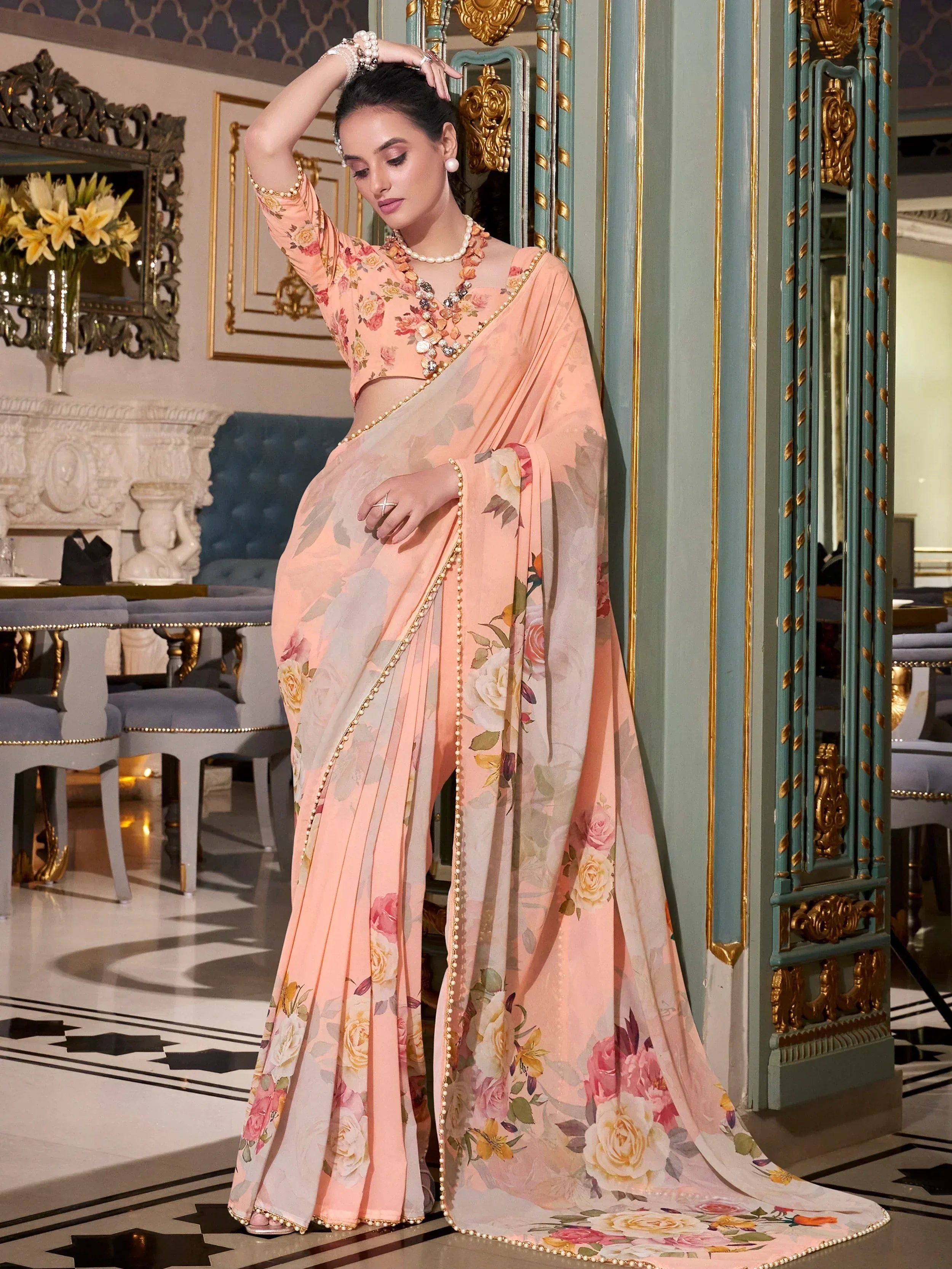 Elegant peach floral saree with gold trim, perfect for Indian ethnic wear occasions