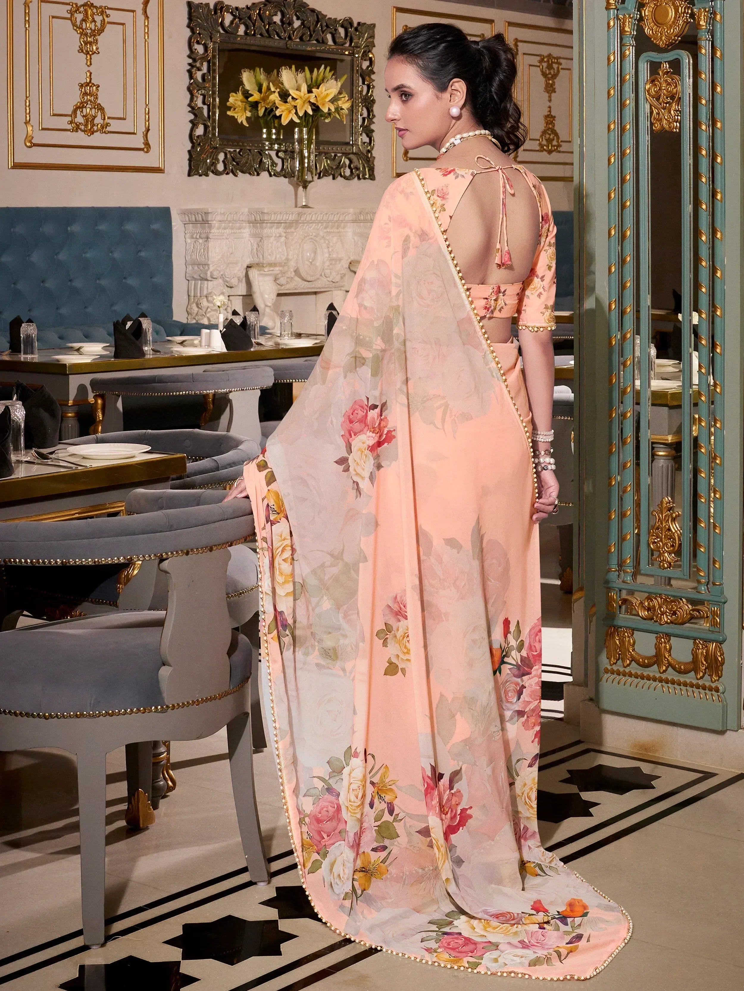 Elegant peach floral saree with gold trim, perfect for Indian ethnic wear occasions