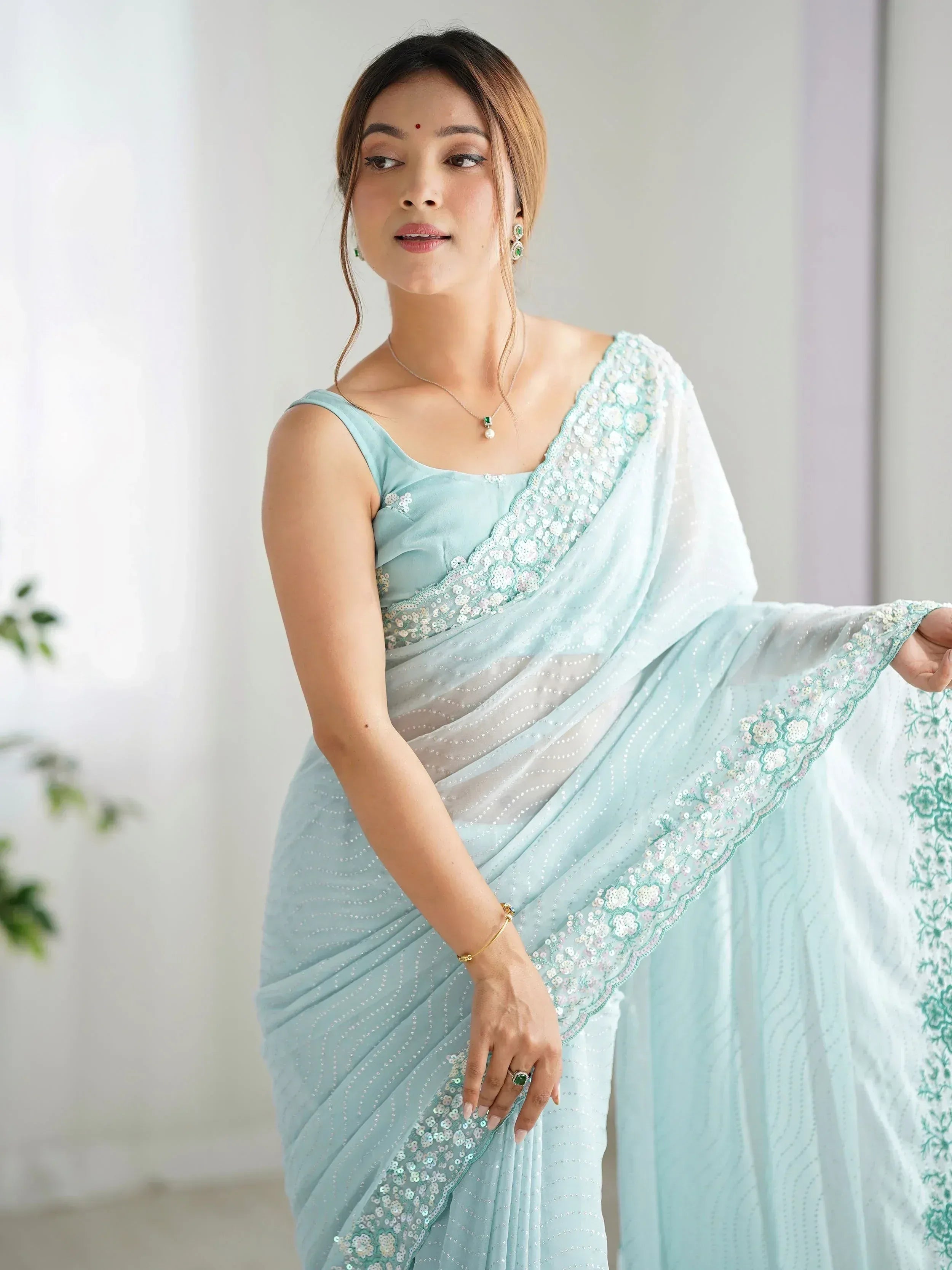 Light blue embroidered saree with sequin detailing, perfect for Indian ethnic occasions