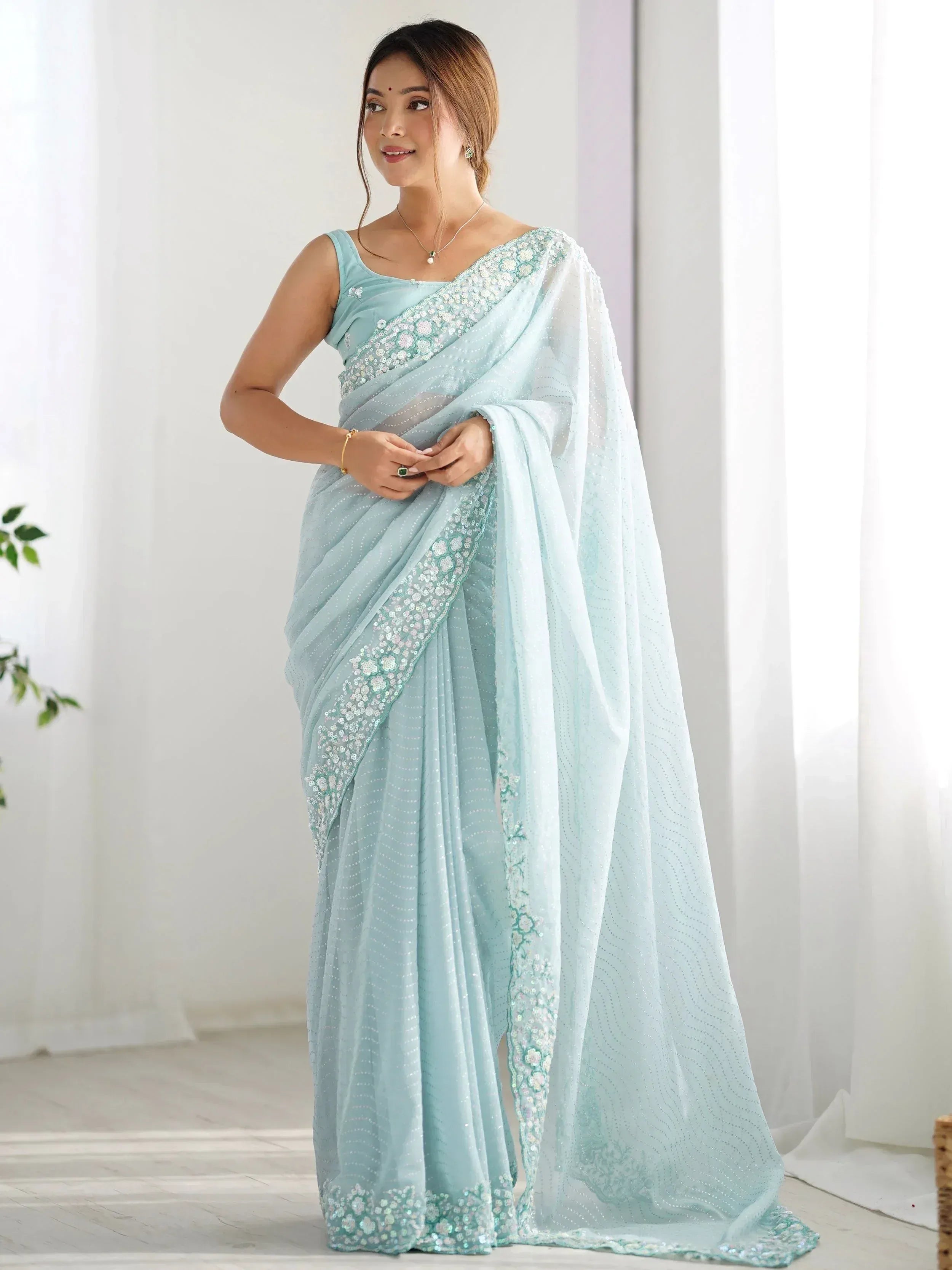 Light blue designer saree with floral sequin work and sheer pallu, perfect for Indian ethnic occasions