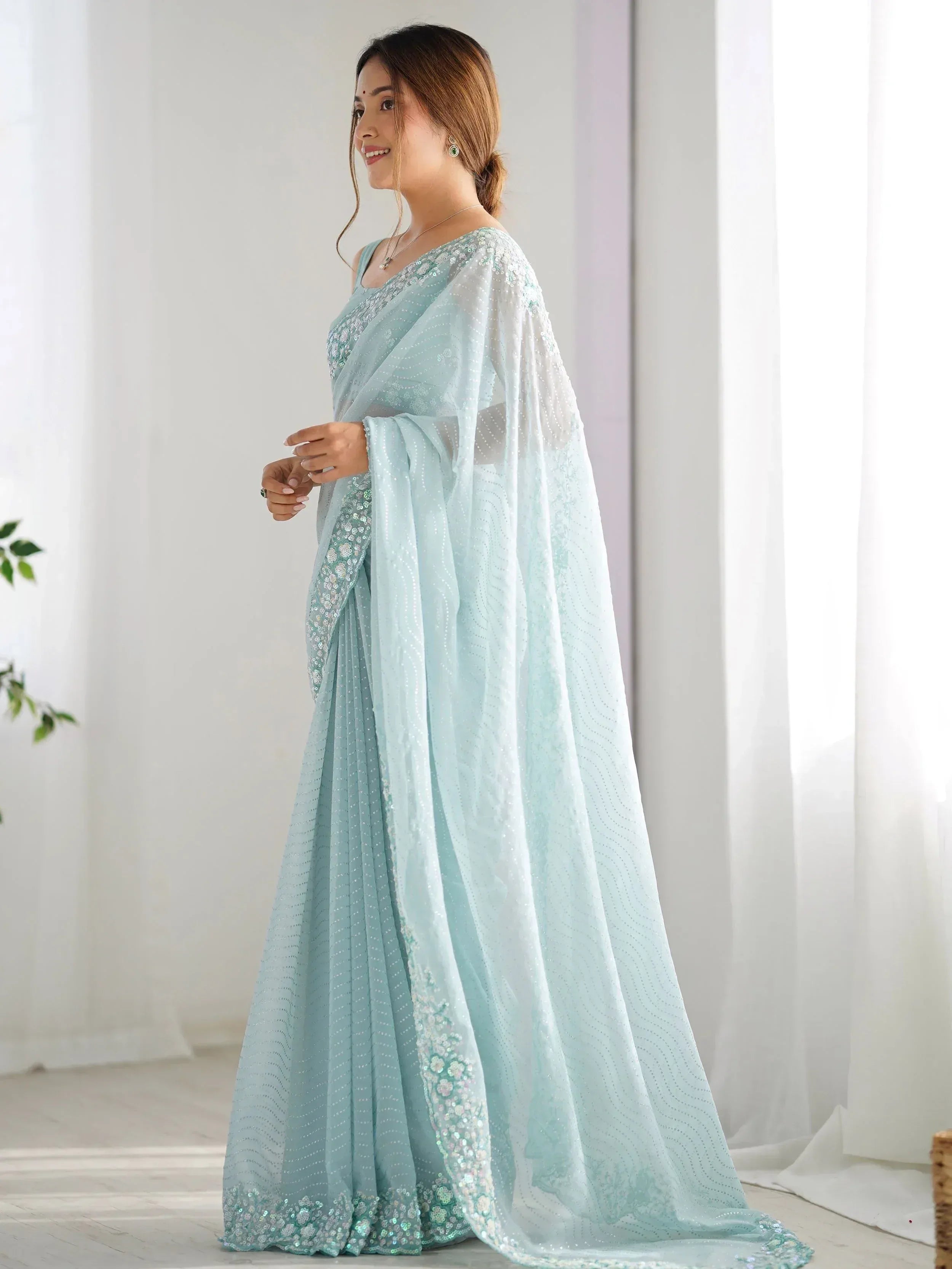 Mint green sequin saree with floral embroidery, perfect for Indian ethnic wear and festive occasions.