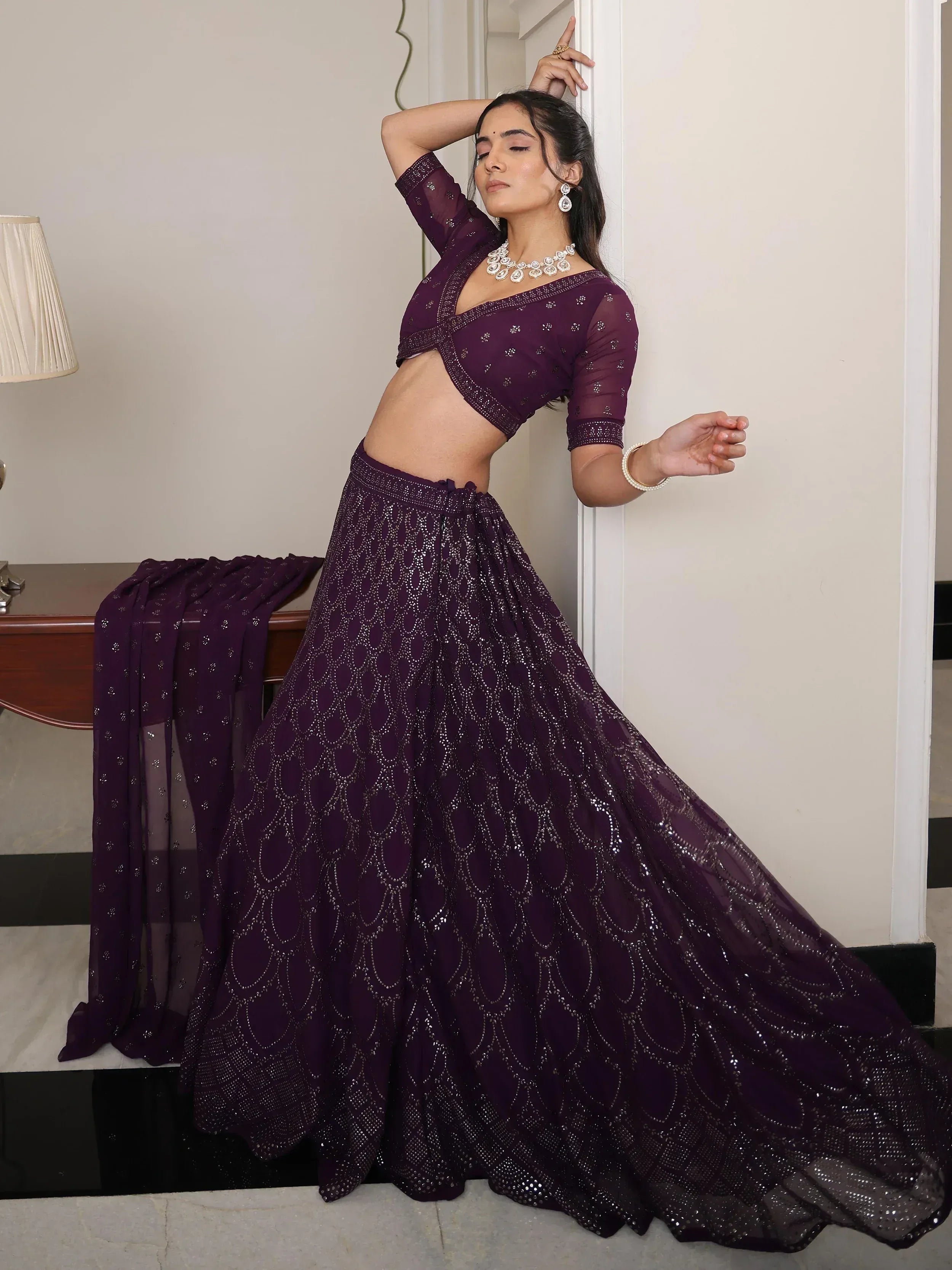 Purple designer lehenga choli with intricate embroidery, perfect for Indian ethnic wear and festive occasions.