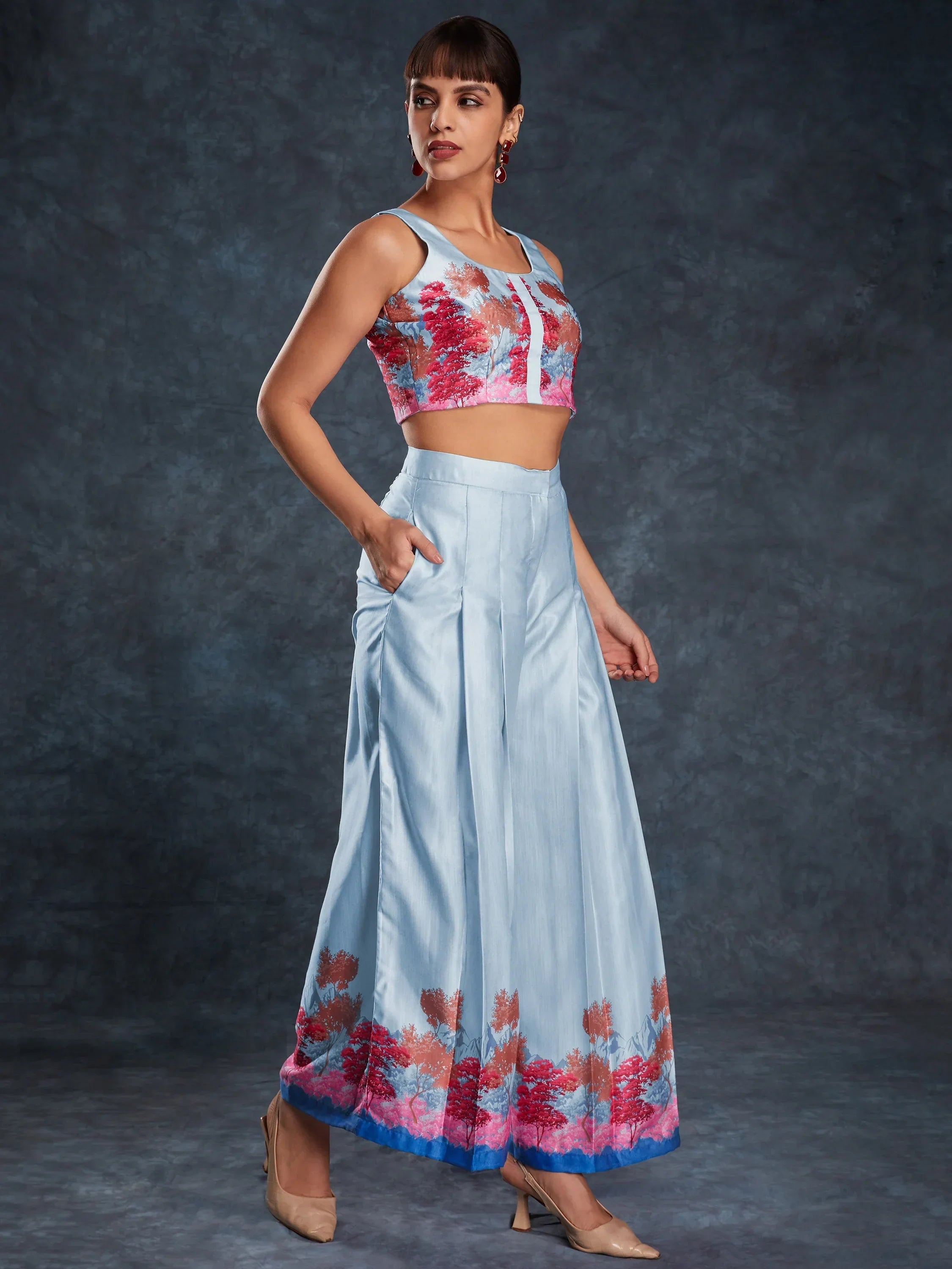 Woman in a stylish light blue ethnic crop top and wide-leg pants with floral print
