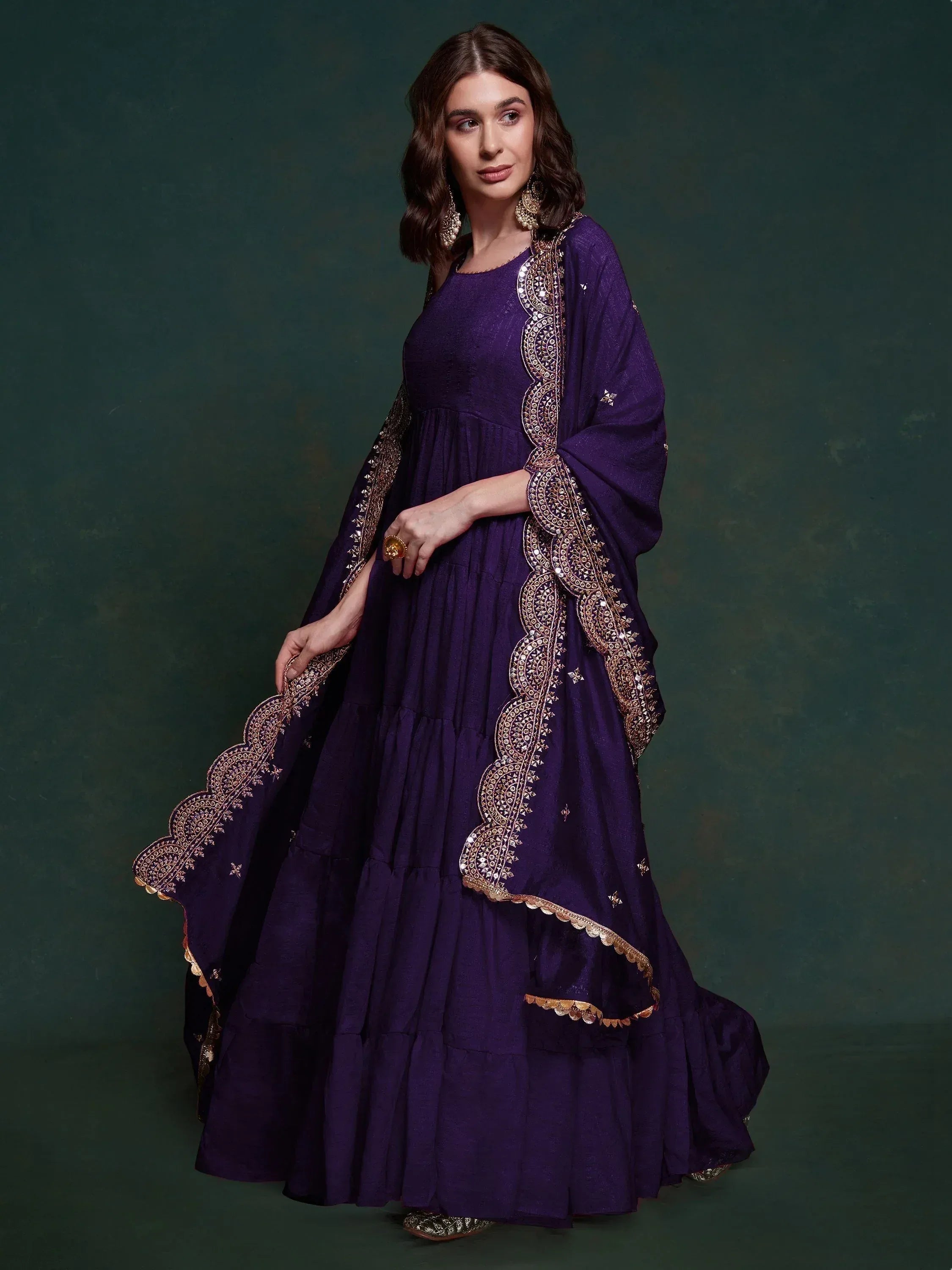 Purple ethnic gown with gold embroidery, perfect for Indian festive occasions and weddings.