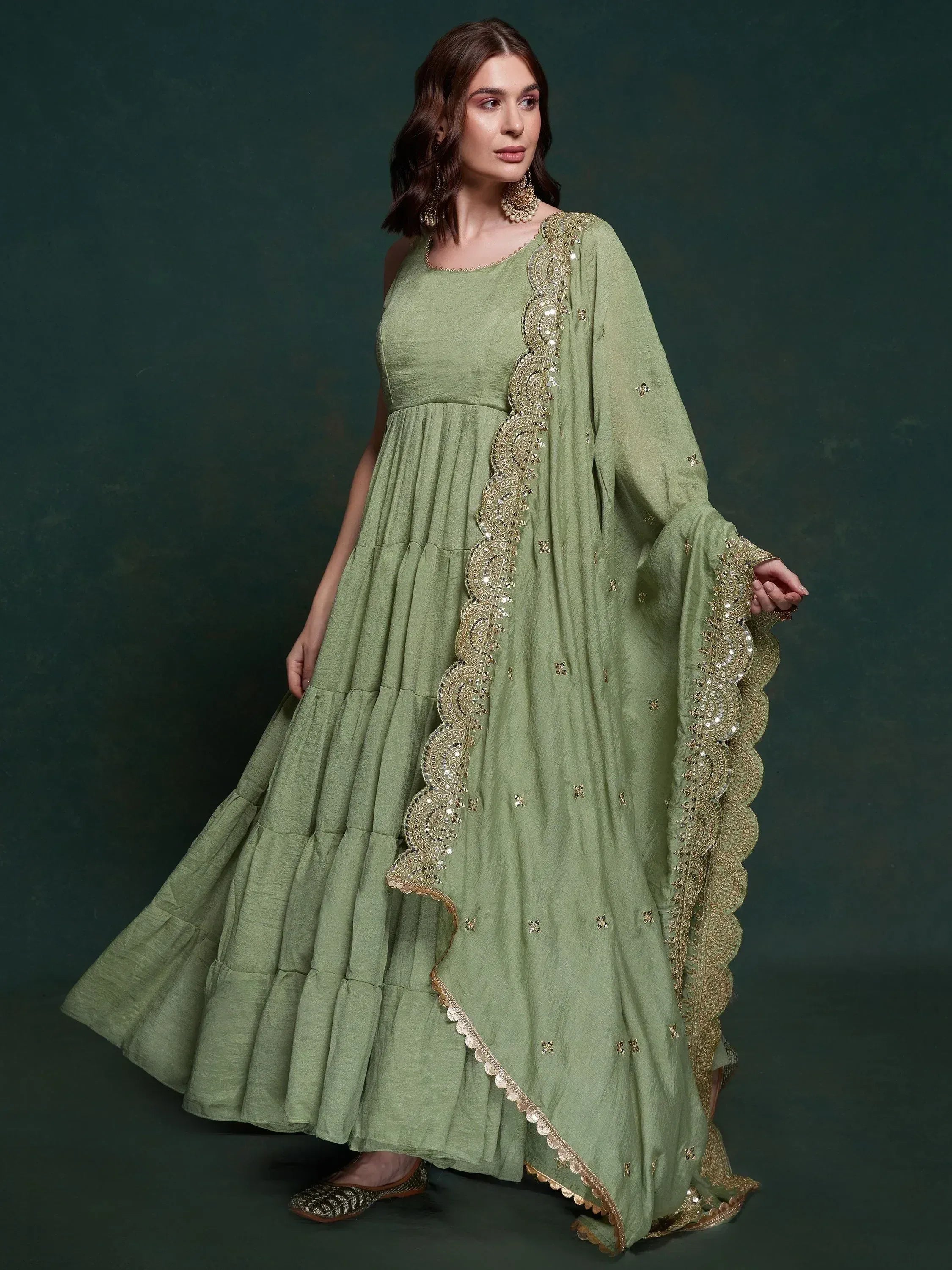 Olive green ethnic gown with gold embroidery and scalloped dupatta, perfect for Indian occasions.