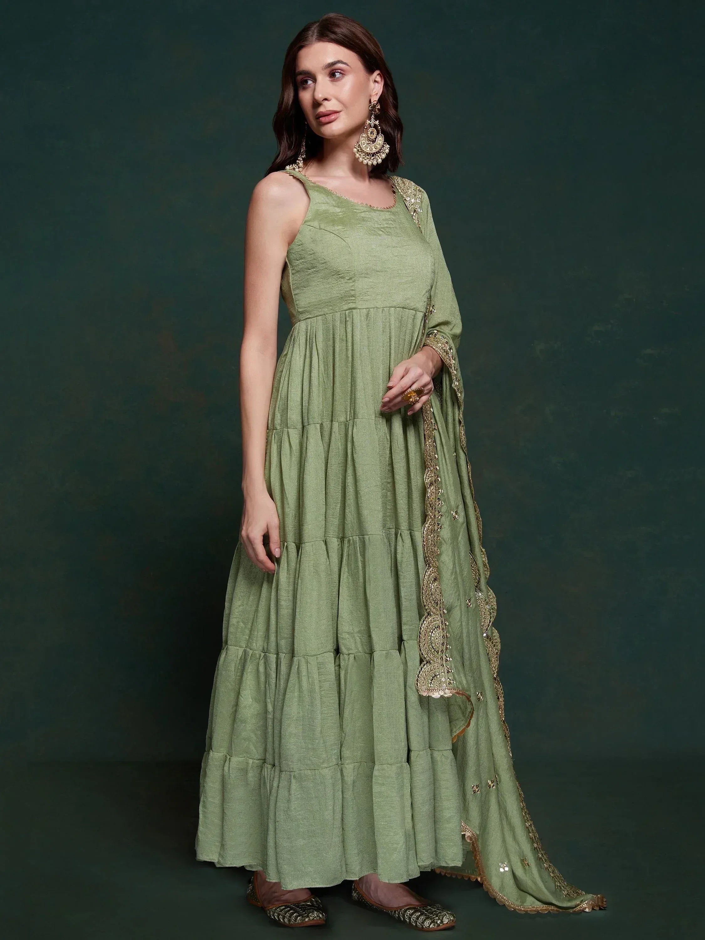 Olive green tiered ethnic gown with gold embroidery and dupatta, perfect for Indian festive occasions.