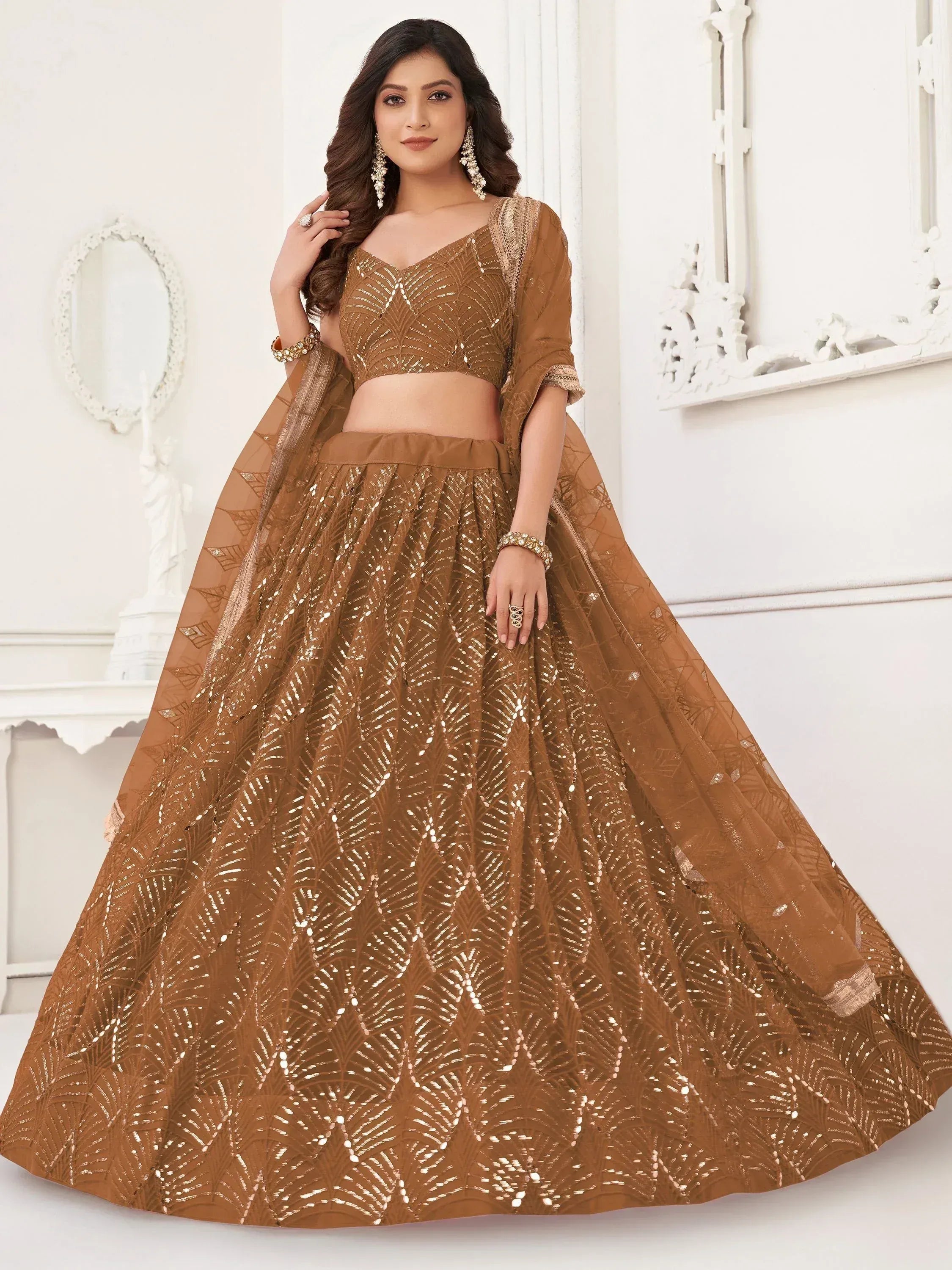 Elegant brown lehenga choli with gold leaf embroidery and sequins, perfect for Indian weddings and festive occasions.