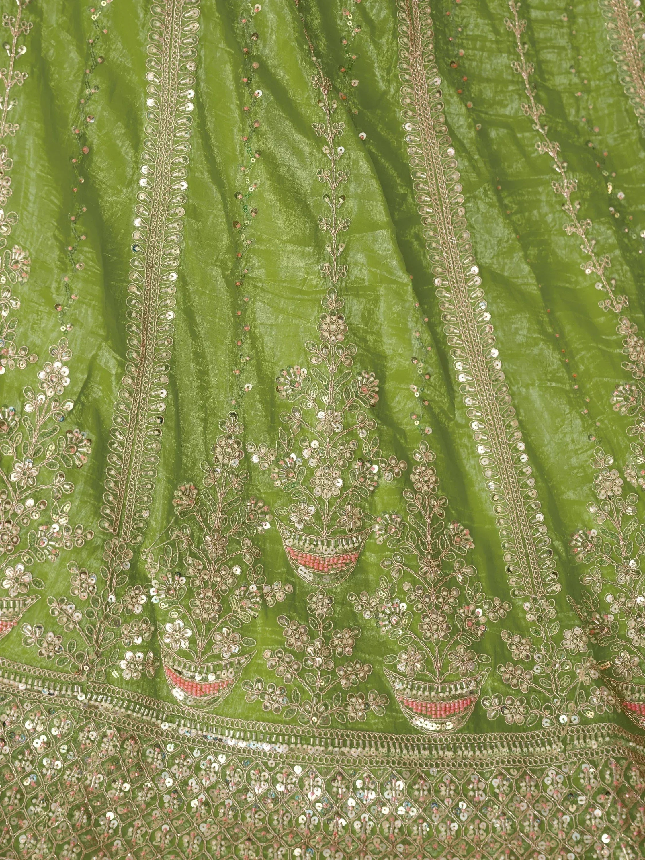 Green ethnic lehenga with floral mirror and sequin embroidery, perfect for Indian weddings and festivals.