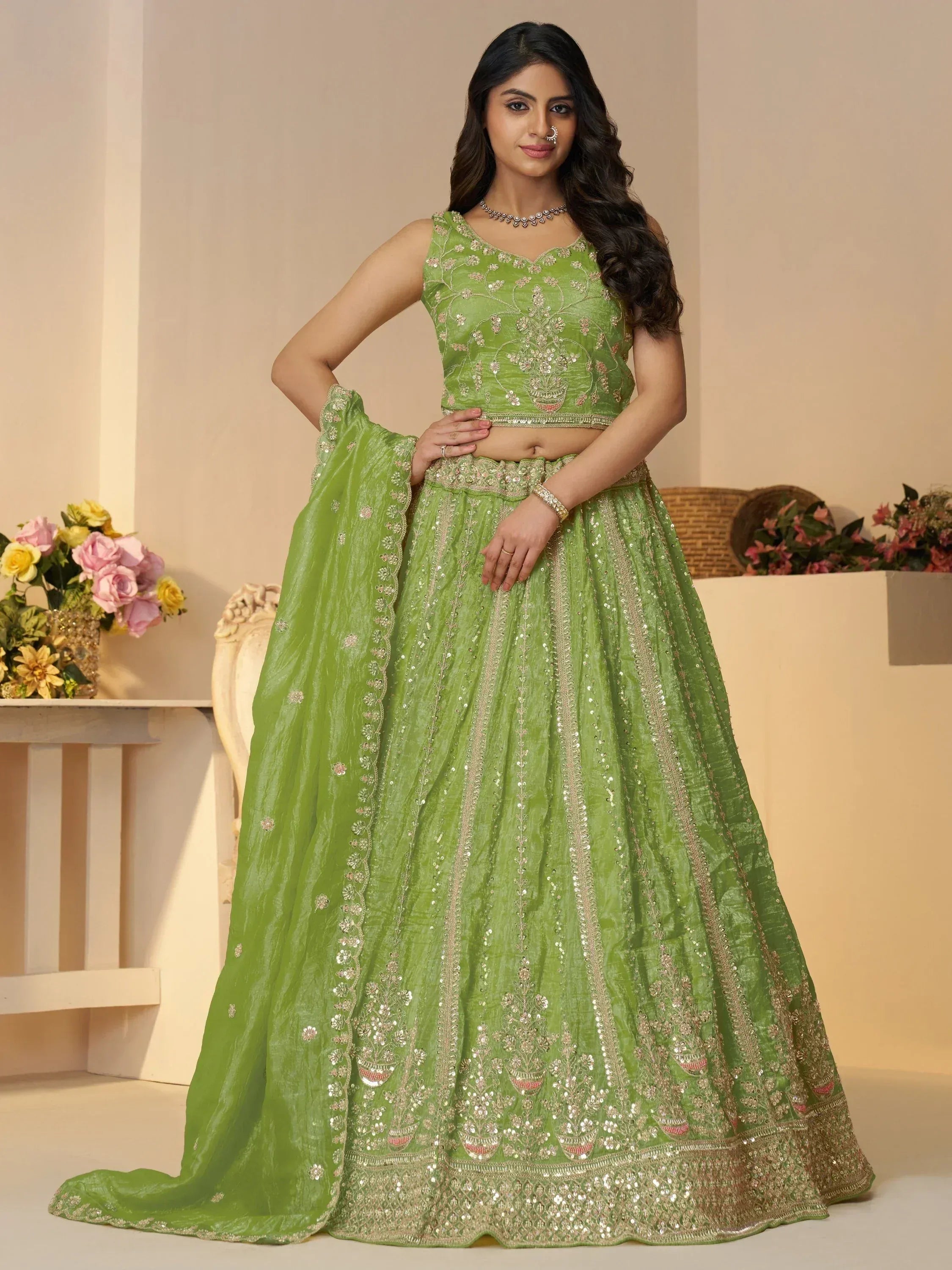 Green embroidered lehenga choli with gold detailing, perfect for Indian weddings and festive occasions.