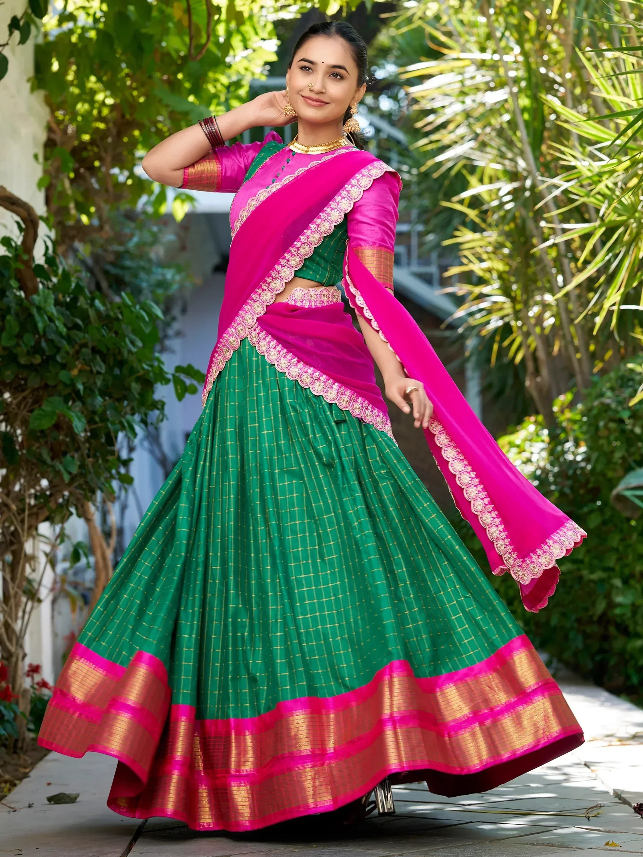 Vibrant green and pink lehenga choli with gold embroidery, perfect for Indian ethnic wear occasions.