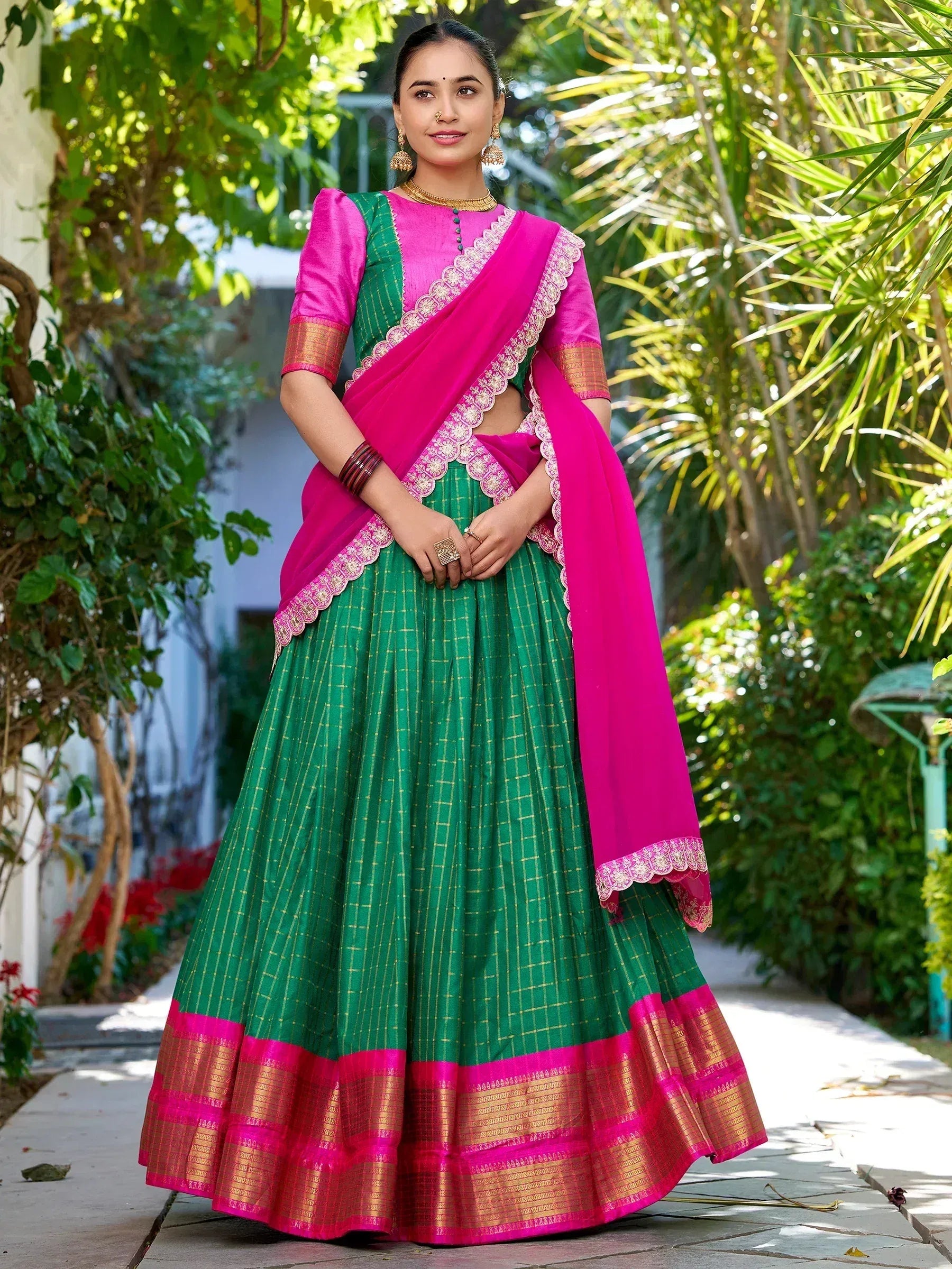 Green and pink designer lehenga choli with gold border, perfect for Indian ethnic wear occasions