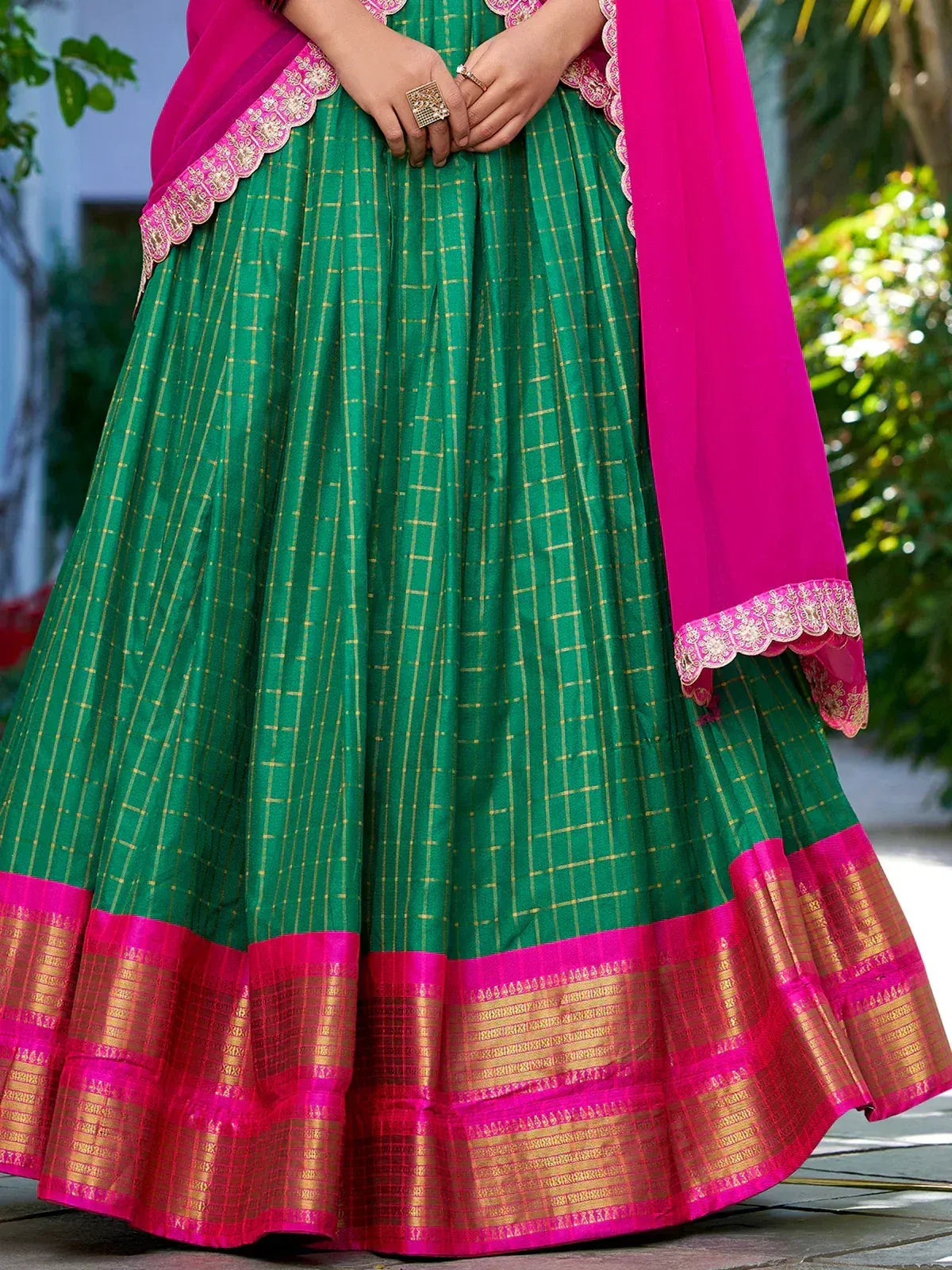 Green and pink ethnic lehenga with gold checks and embroidered dupatta, perfect for Indian festivals and weddings.