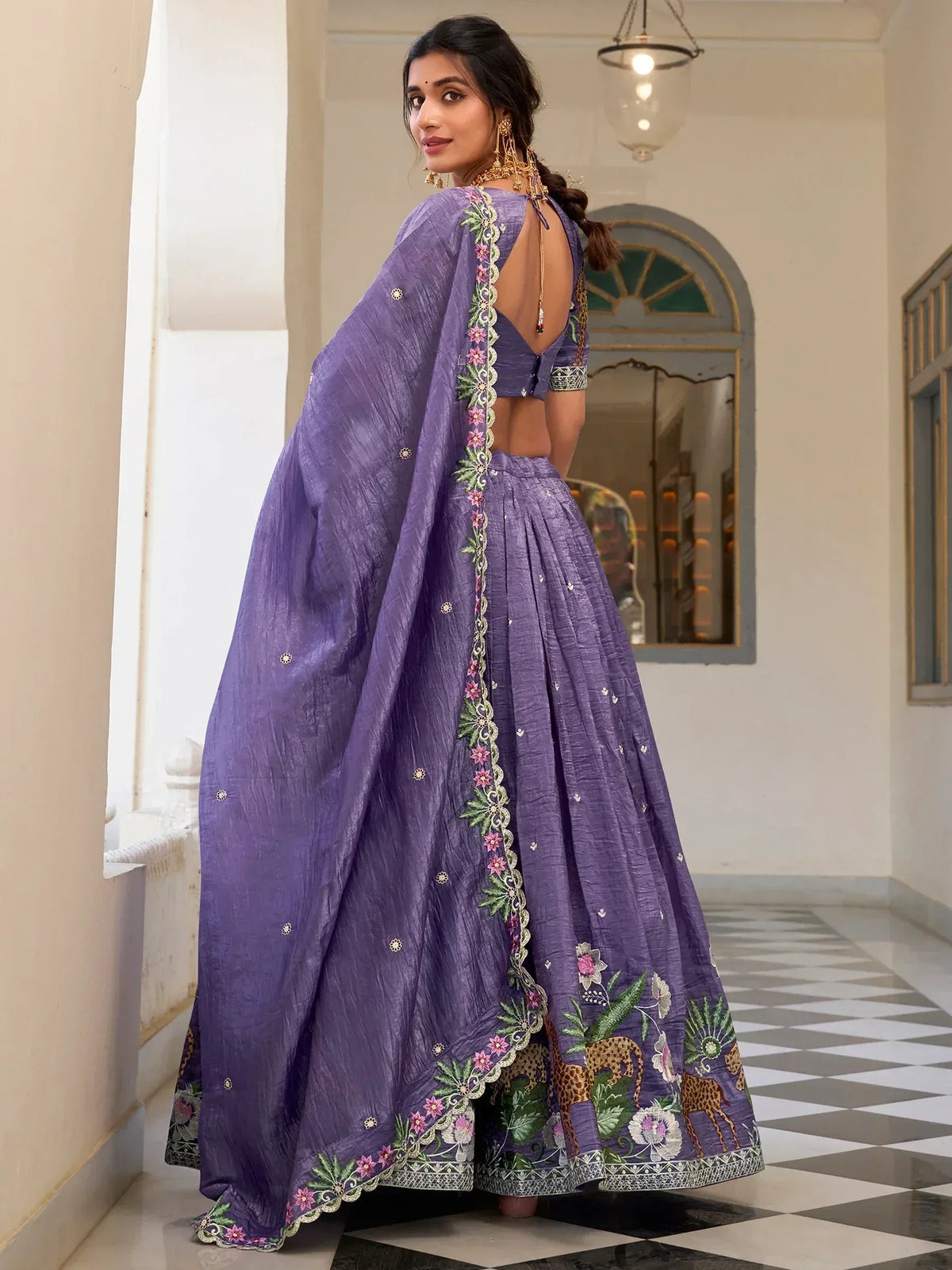 Purple embroidered lehenga choli with floral and animal motifs, backless blouse, and dupatta