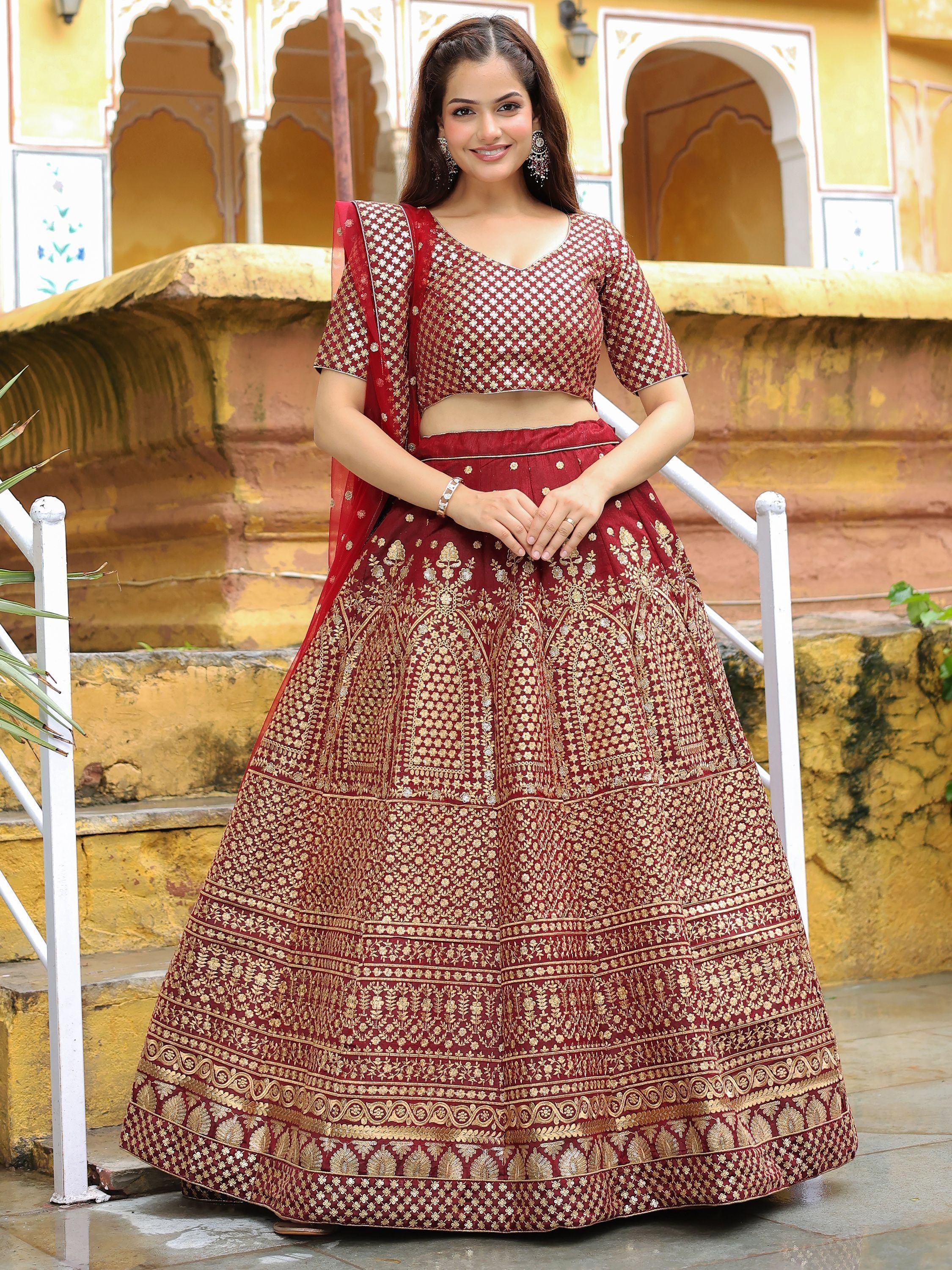 Maroon embroidered lehenga choli with gold floral motifs, perfect for Indian ethnic wear and festive occasions.
