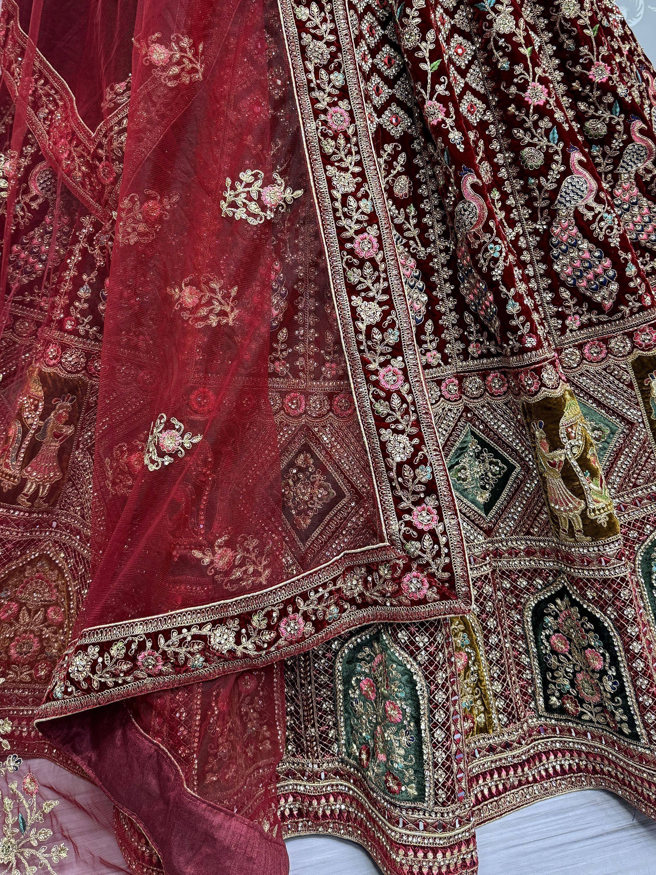 Luxury maroon velvet lehenga with intricate floral and peacock embroidery, perfect for Indian weddings and festive occasions.