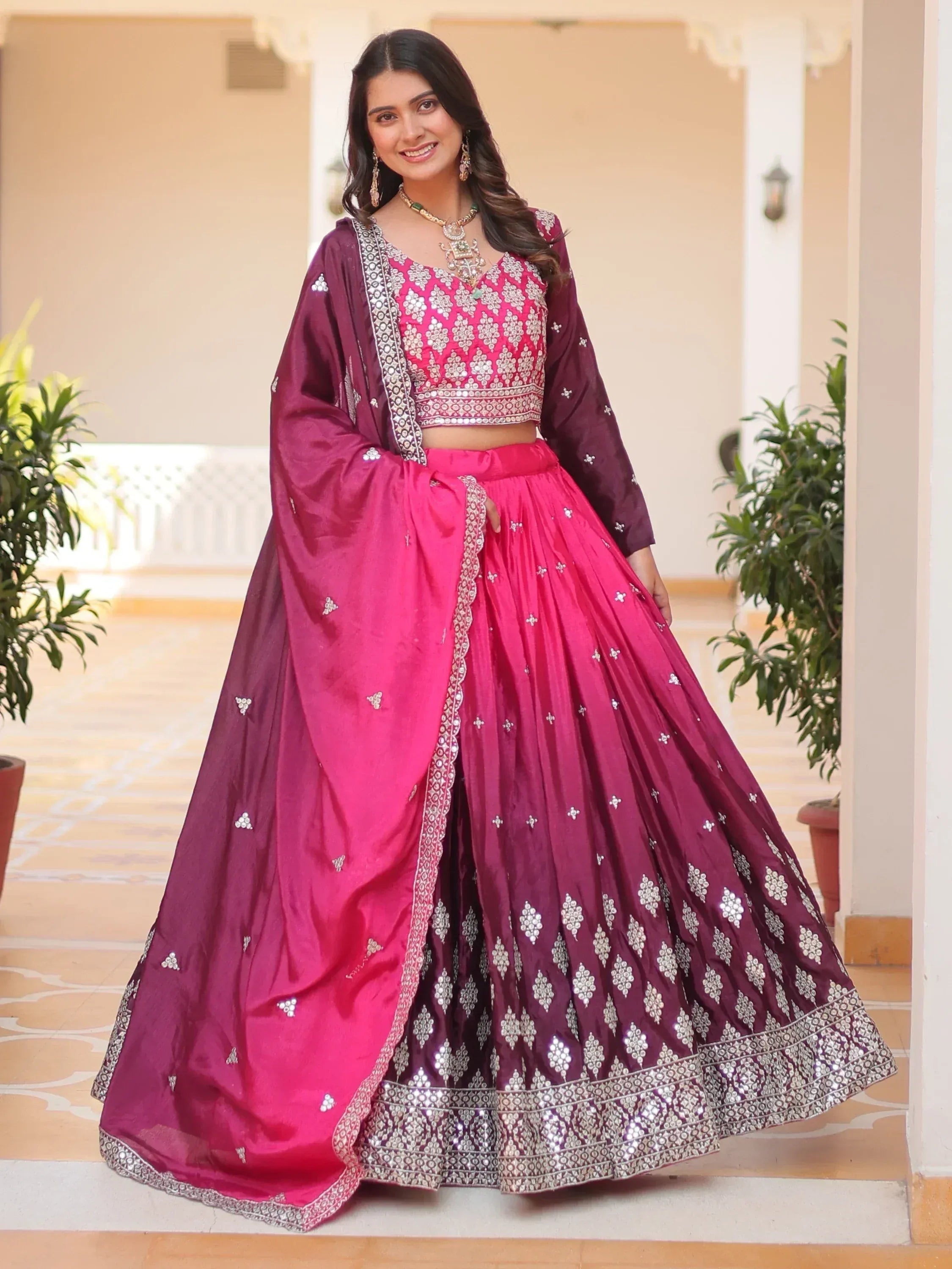 Pink and maroon designer lehenga choli with mirror work, perfect for Indian weddings and festive occasions