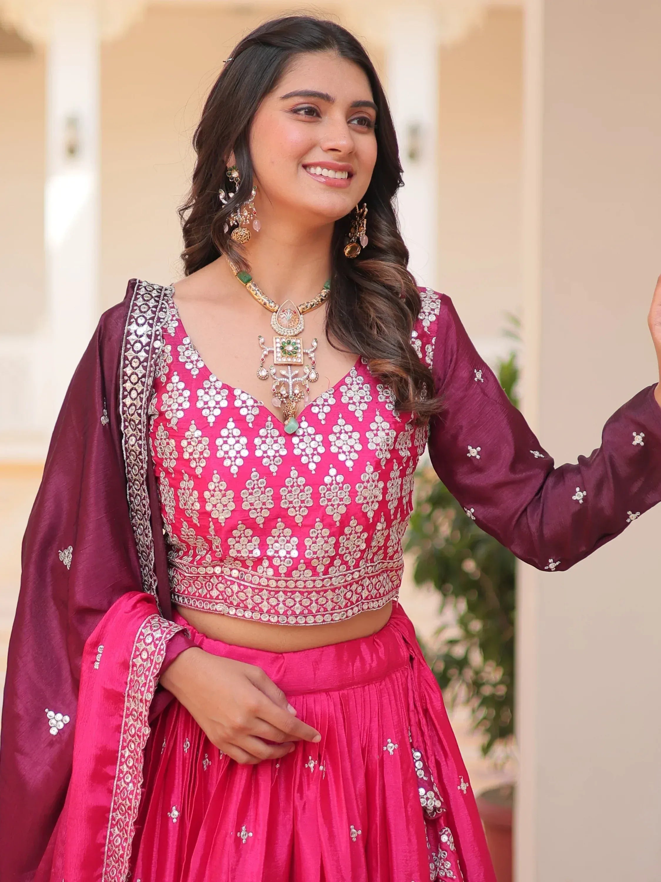 Pink and maroon designer lehenga choli with mirror work, perfect for Indian ethnic wear occasions.