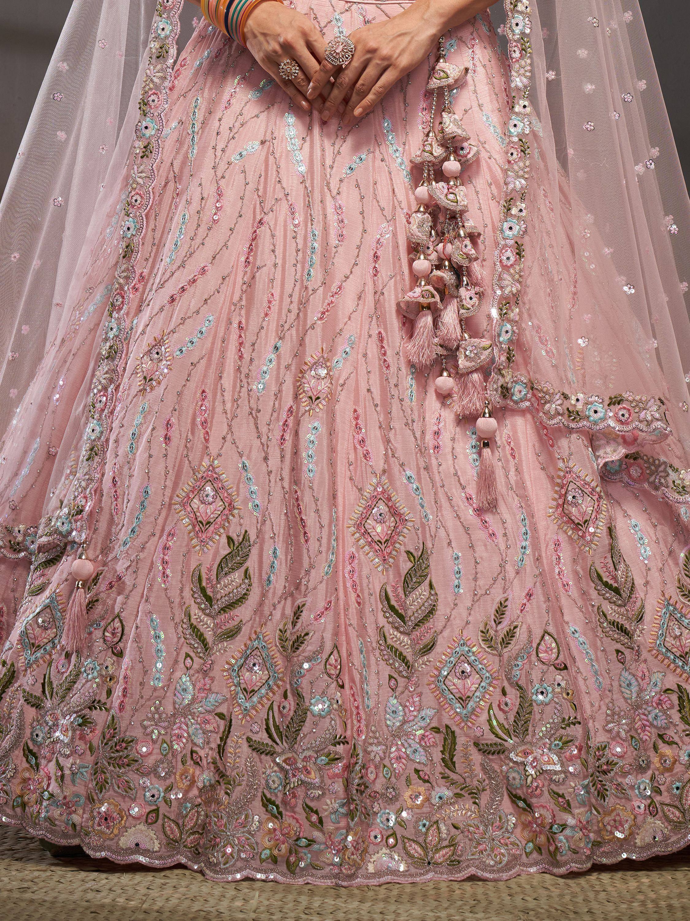 Pink embroidered lehenga with floral motifs, tassels, and mirror work for Indian ethnic wear