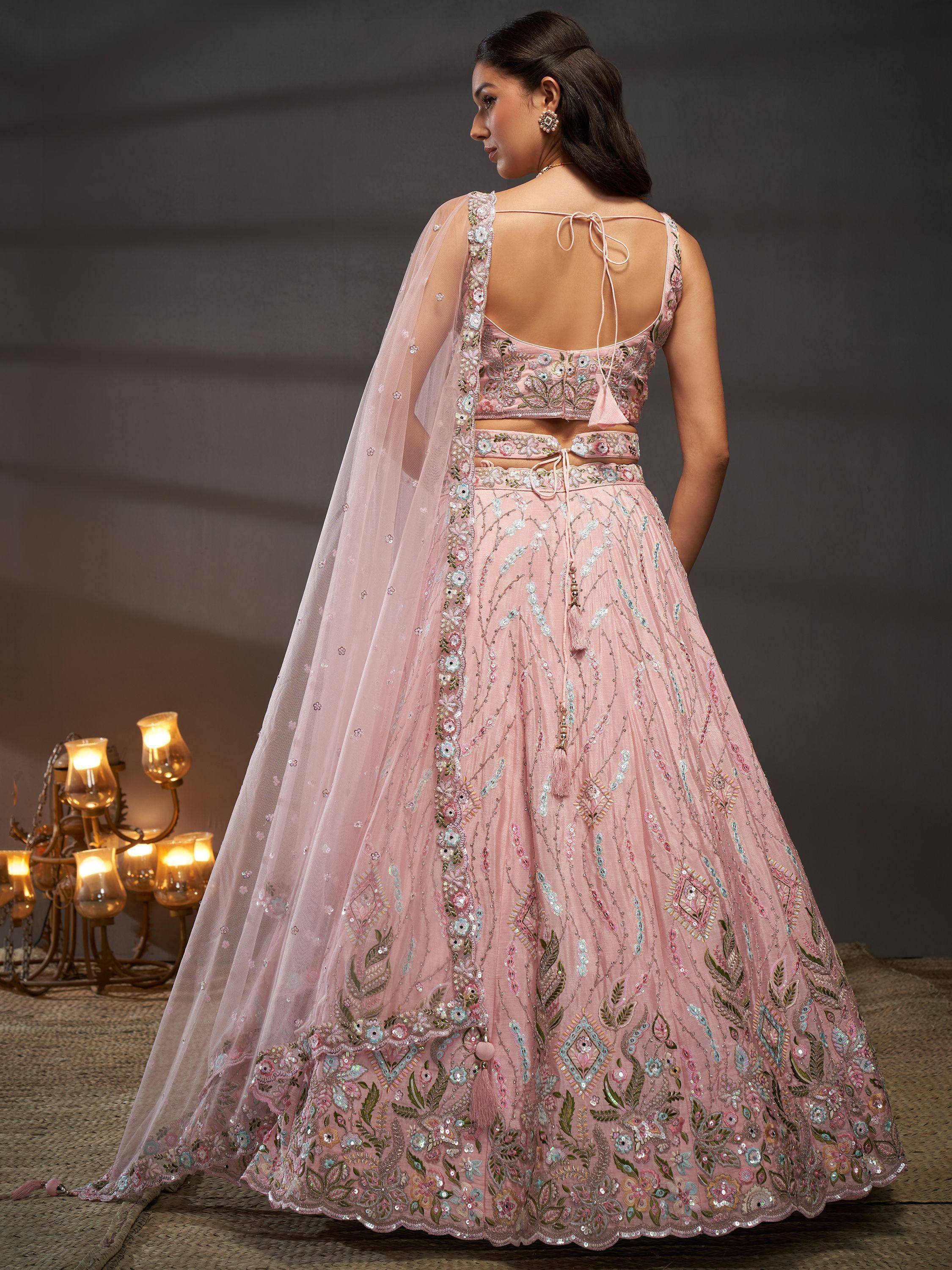 Pink embroidered lehenga choli with floral motifs and sheer dupatta, ideal for Indian weddings and festive occasions.