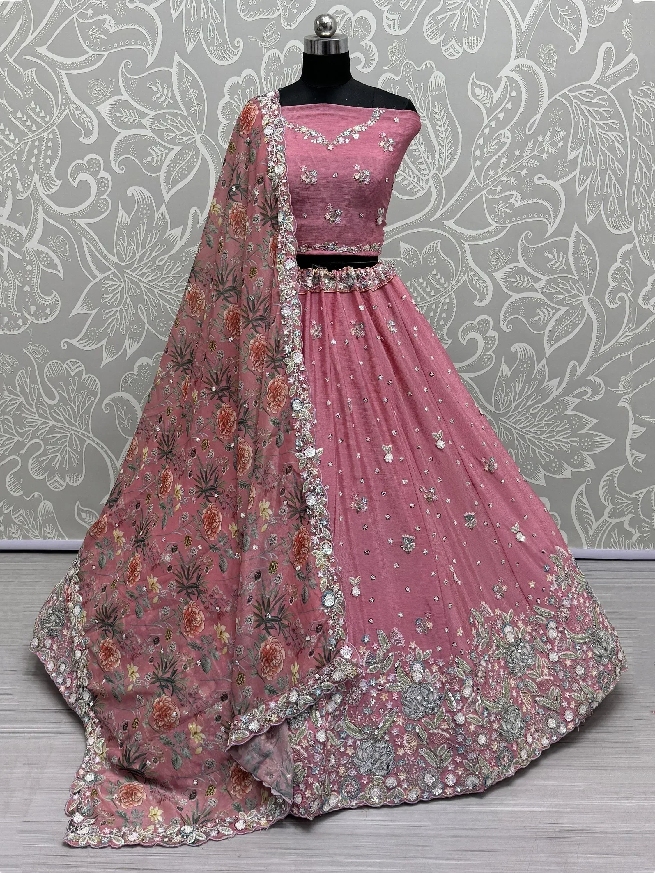 Pink designer lehenga choli with floral dupatta, perfect for Indian weddings and festive occasions