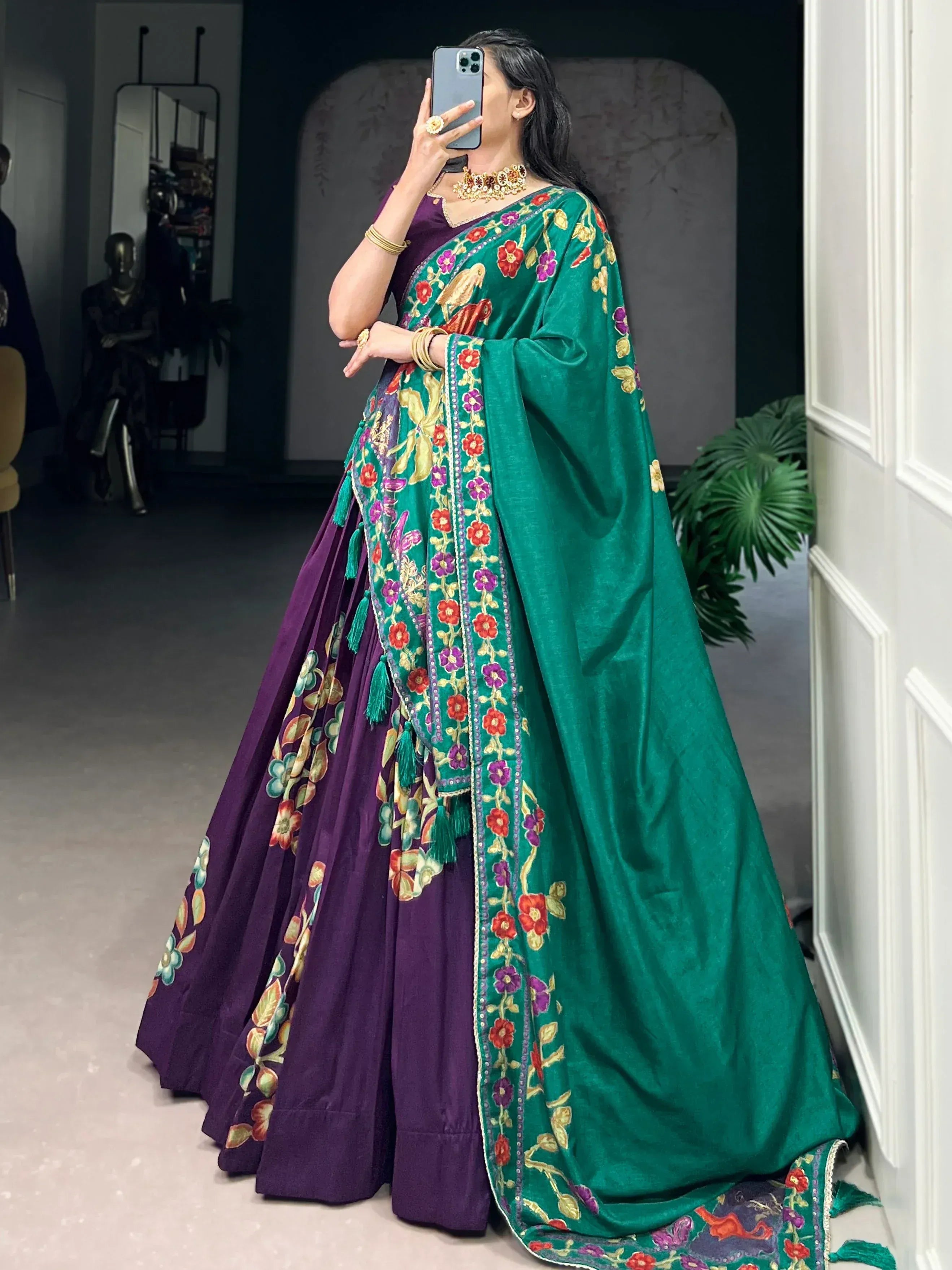 Purple and green embroidered lehenga choli with floral motifs, perfect for Indian ethnic wear occasions.