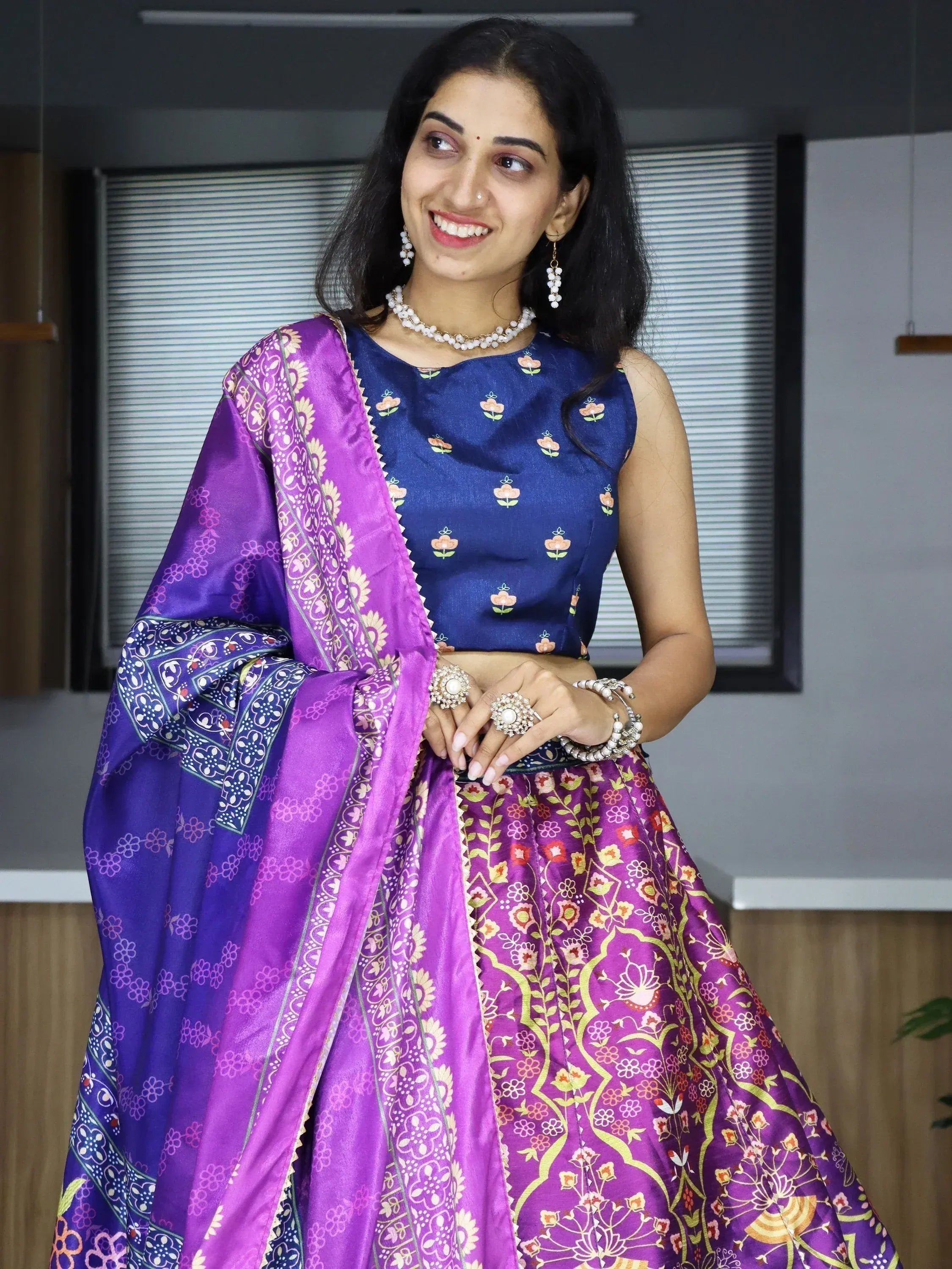 Woman in purple floral lehenga choli with blue blouse, traditional Indian ethnic wear