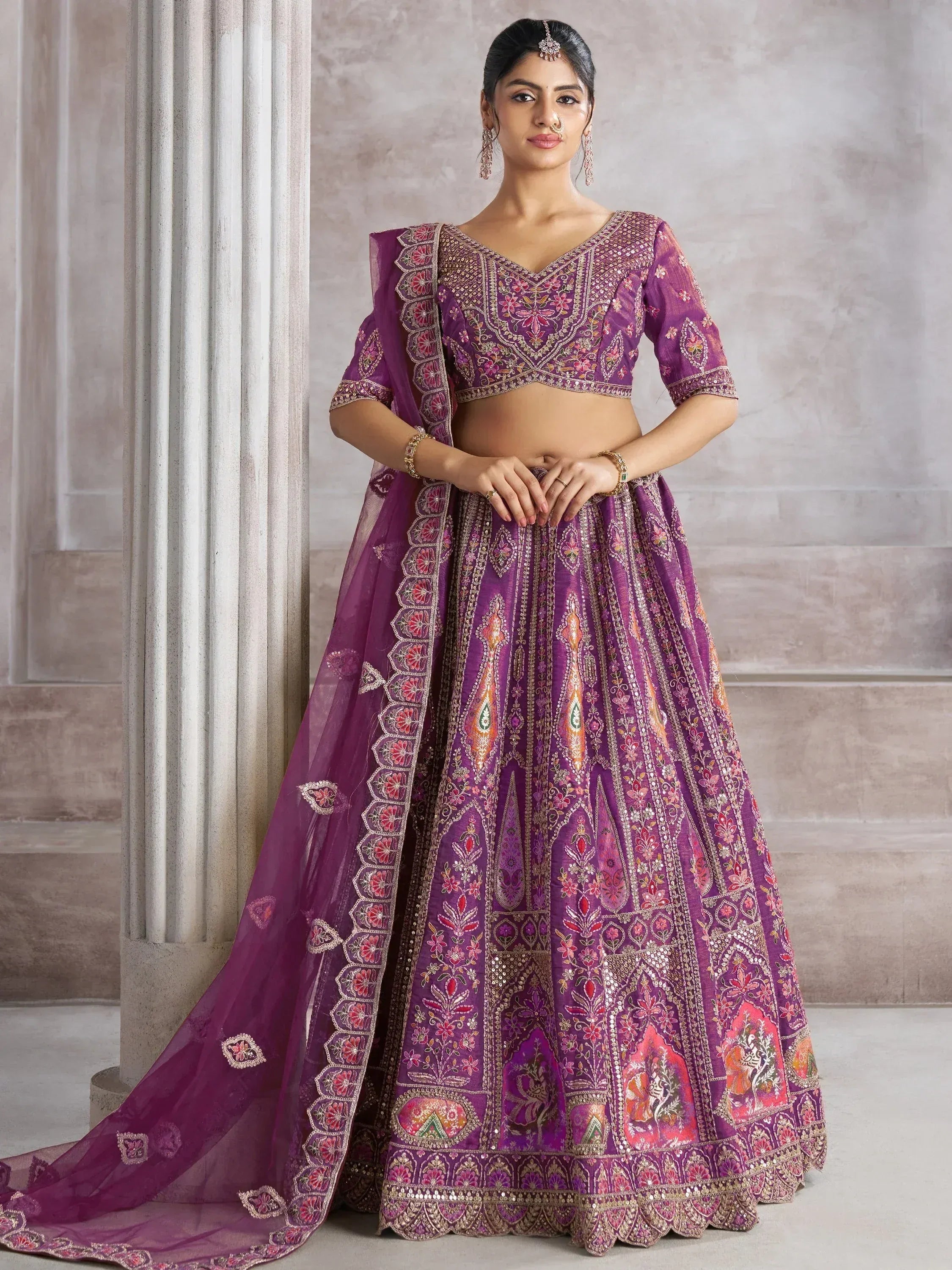 Purple embroidered lehenga choli with floral motifs and dupatta, perfect for Indian weddings and festive occasions