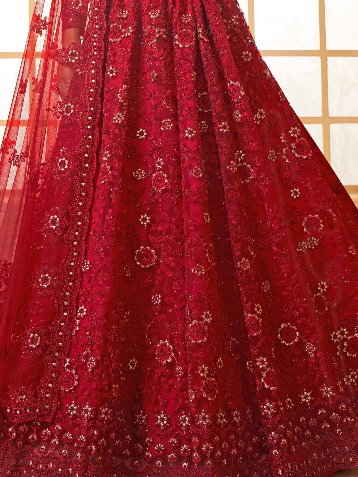 Red embroidered lehenga choli with floral gold detailing and sheer dupatta, perfect for Indian weddings