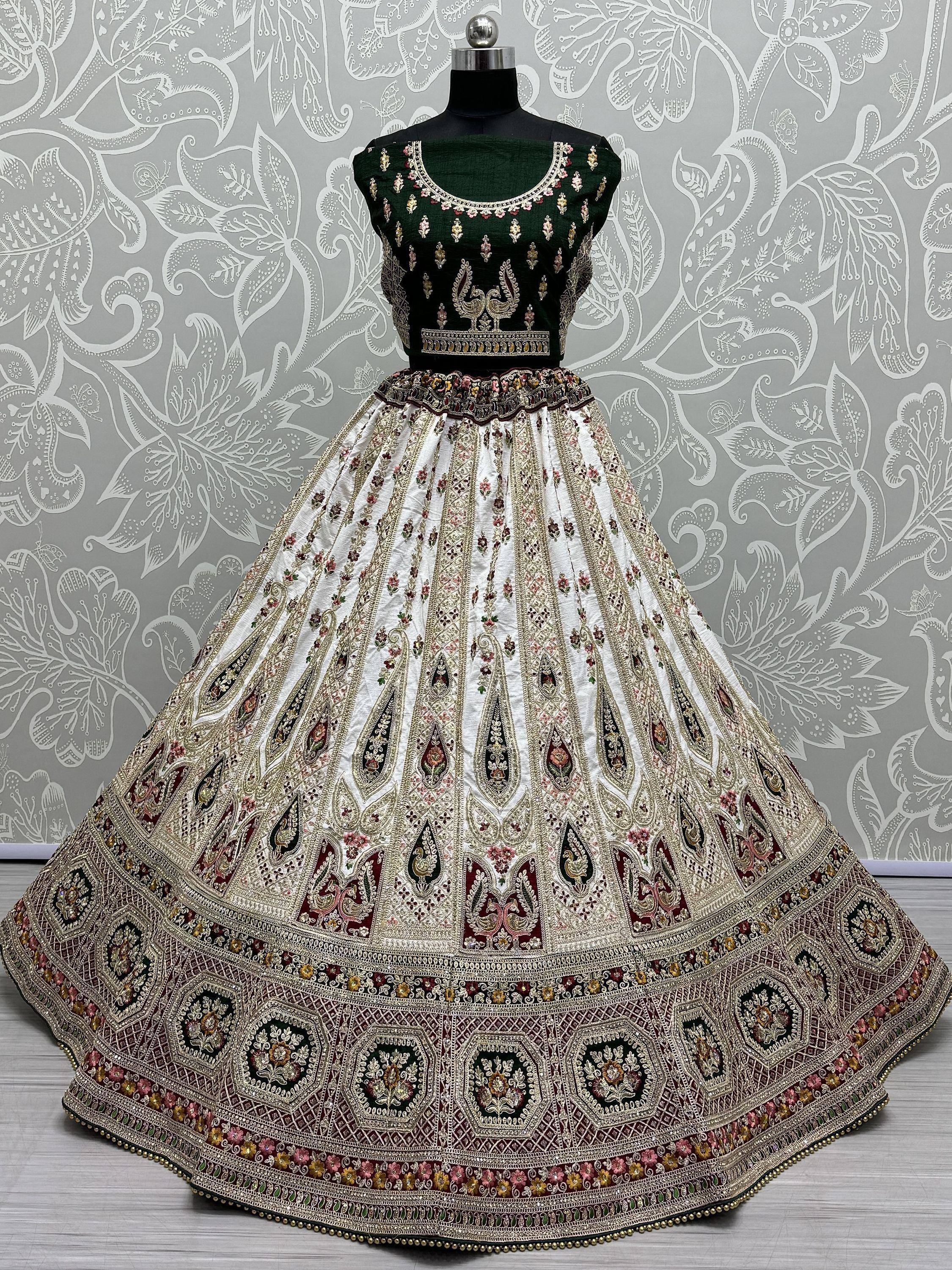 Designer lehenga choli with green velvet blouse and embroidered white skirt, ethnic Indian wear