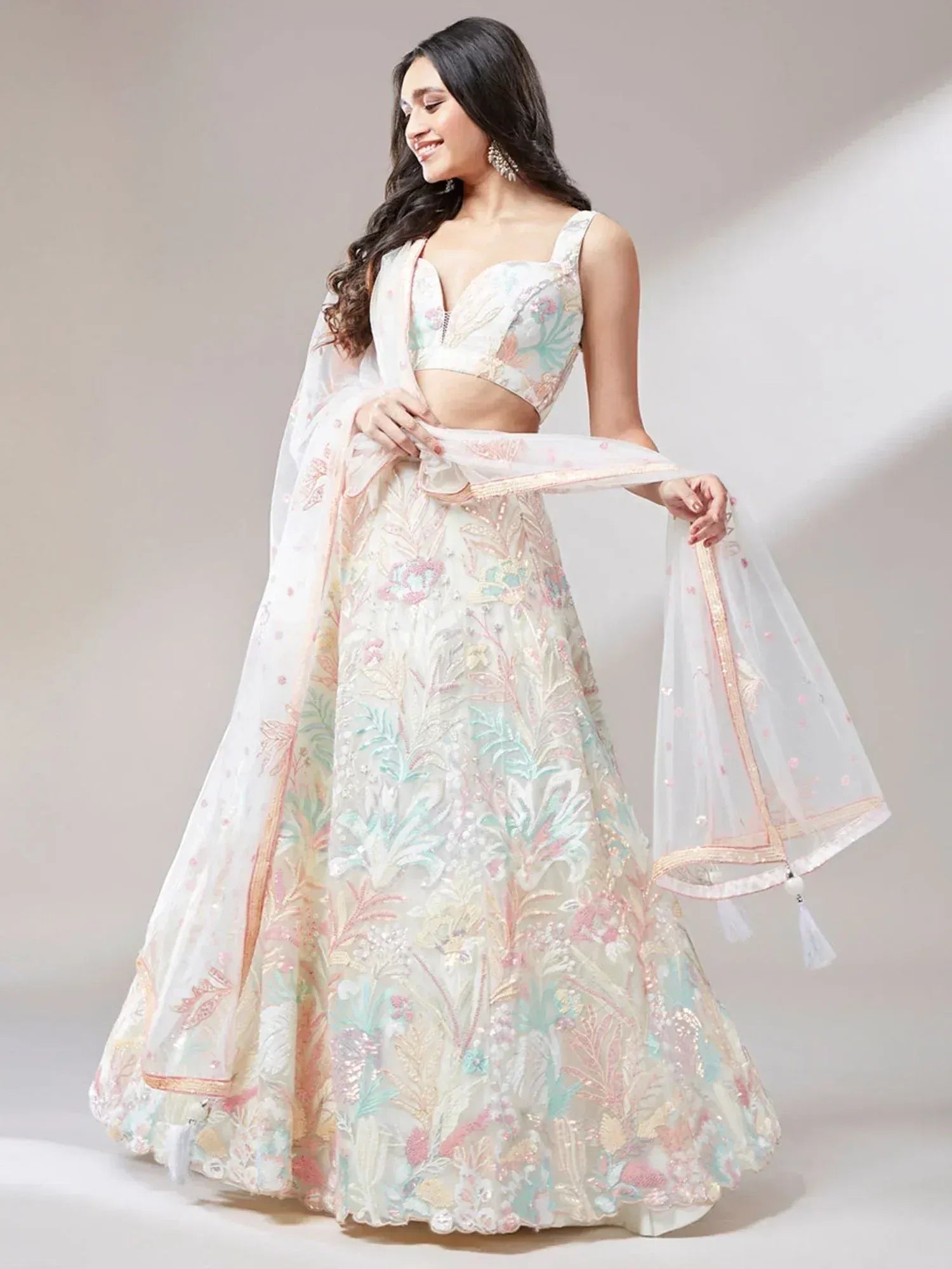 Elegant white lehenga choli with pastel floral embroidery and sheer dupatta for Indian ethnic wear