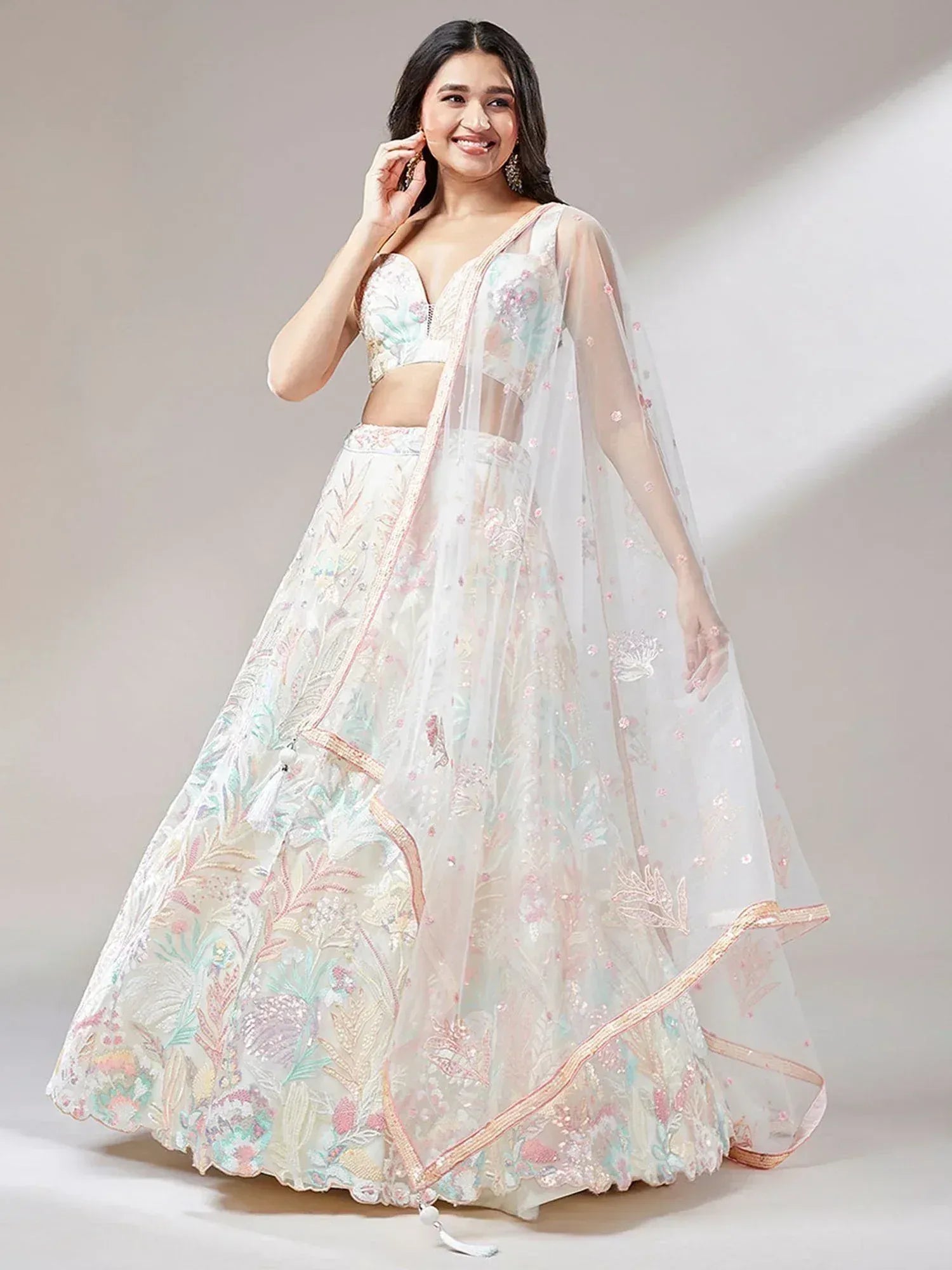 Elegant white lehenga choli with pastel floral embroidery and sheer dupatta for Indian ethnic wear