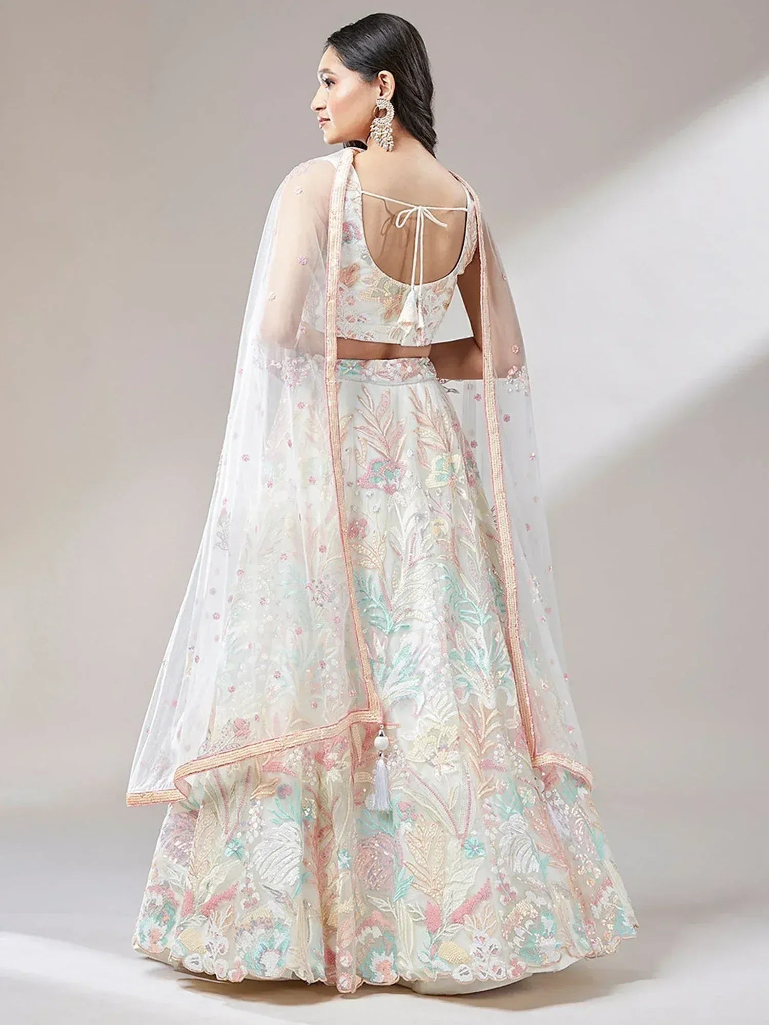 Elegant floral embroidered lehenga choli with sheer dupatta, perfect for Indian weddings and festive occasions.