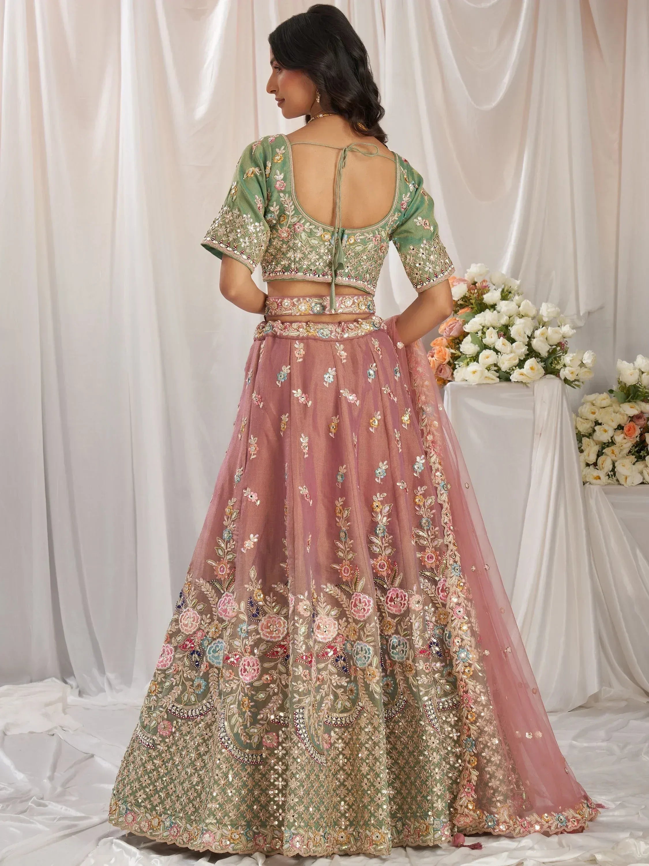 Woman in floral embroidered lehenga choli with backless blouse, Indian ethnic wear