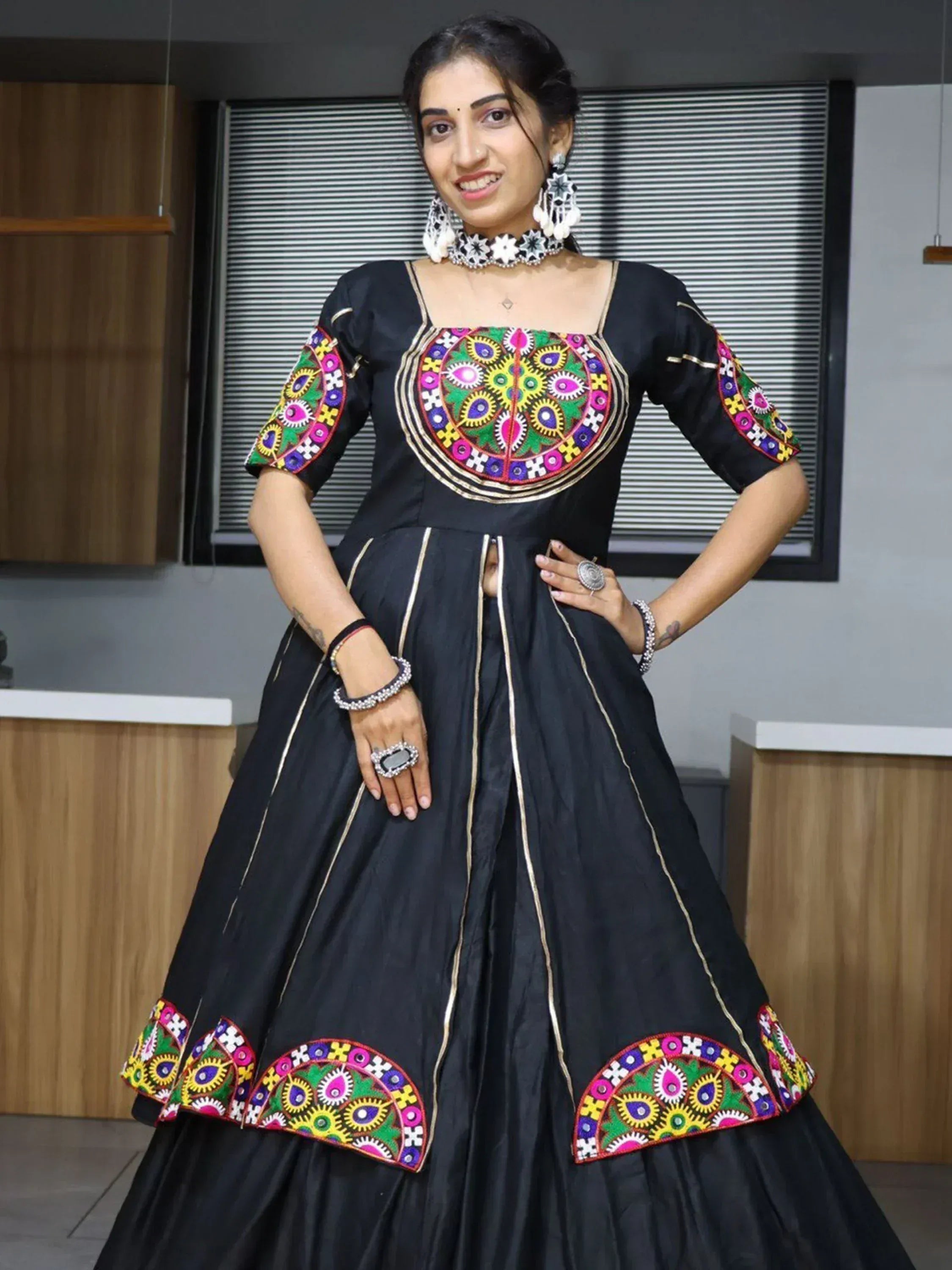 Black ethnic gown with colorful mirror work embroidery, perfect for Indian festive occasions and parties.