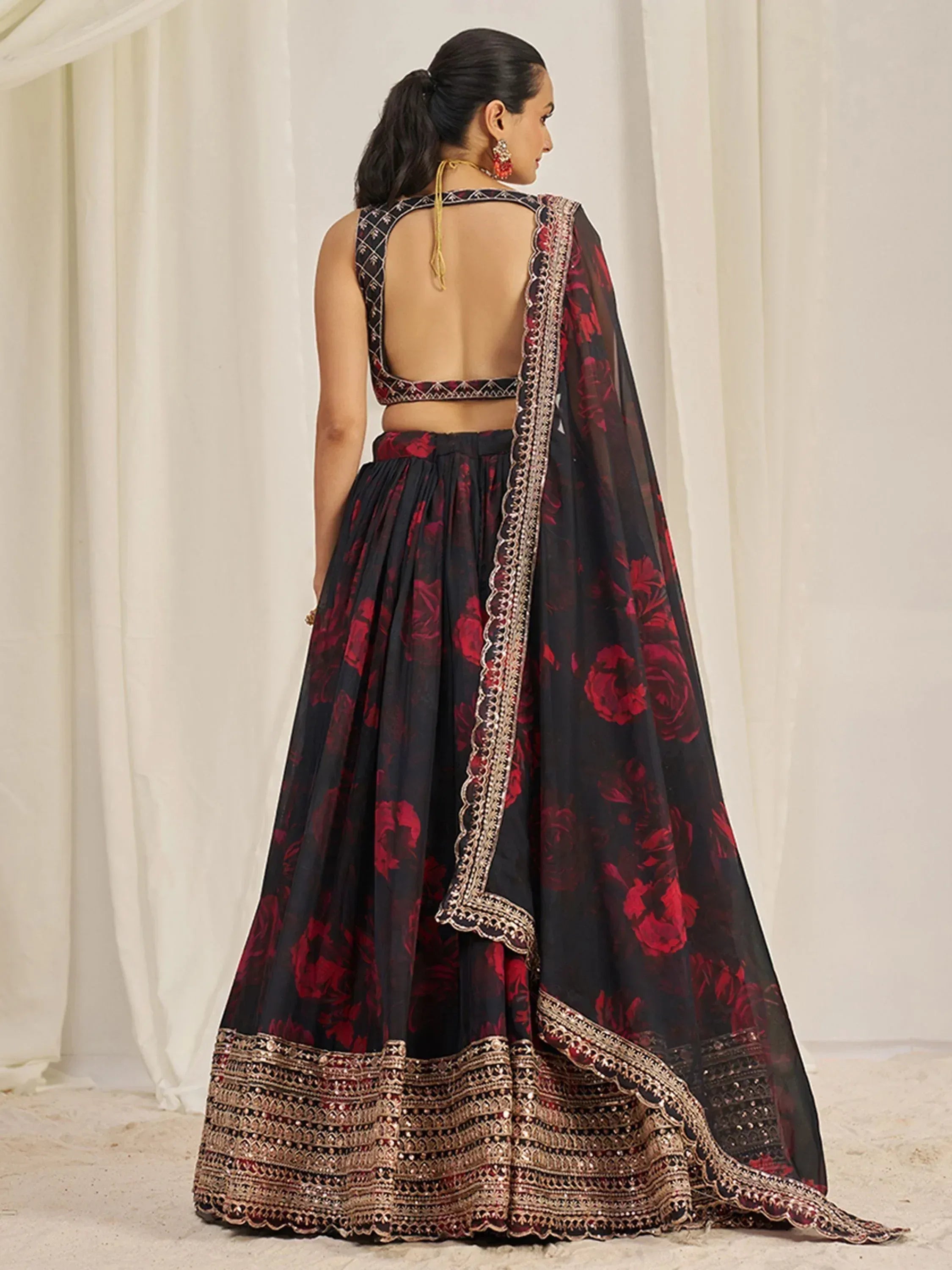 Black and red floral lehenga choli with gold embroidery and backless blouse design