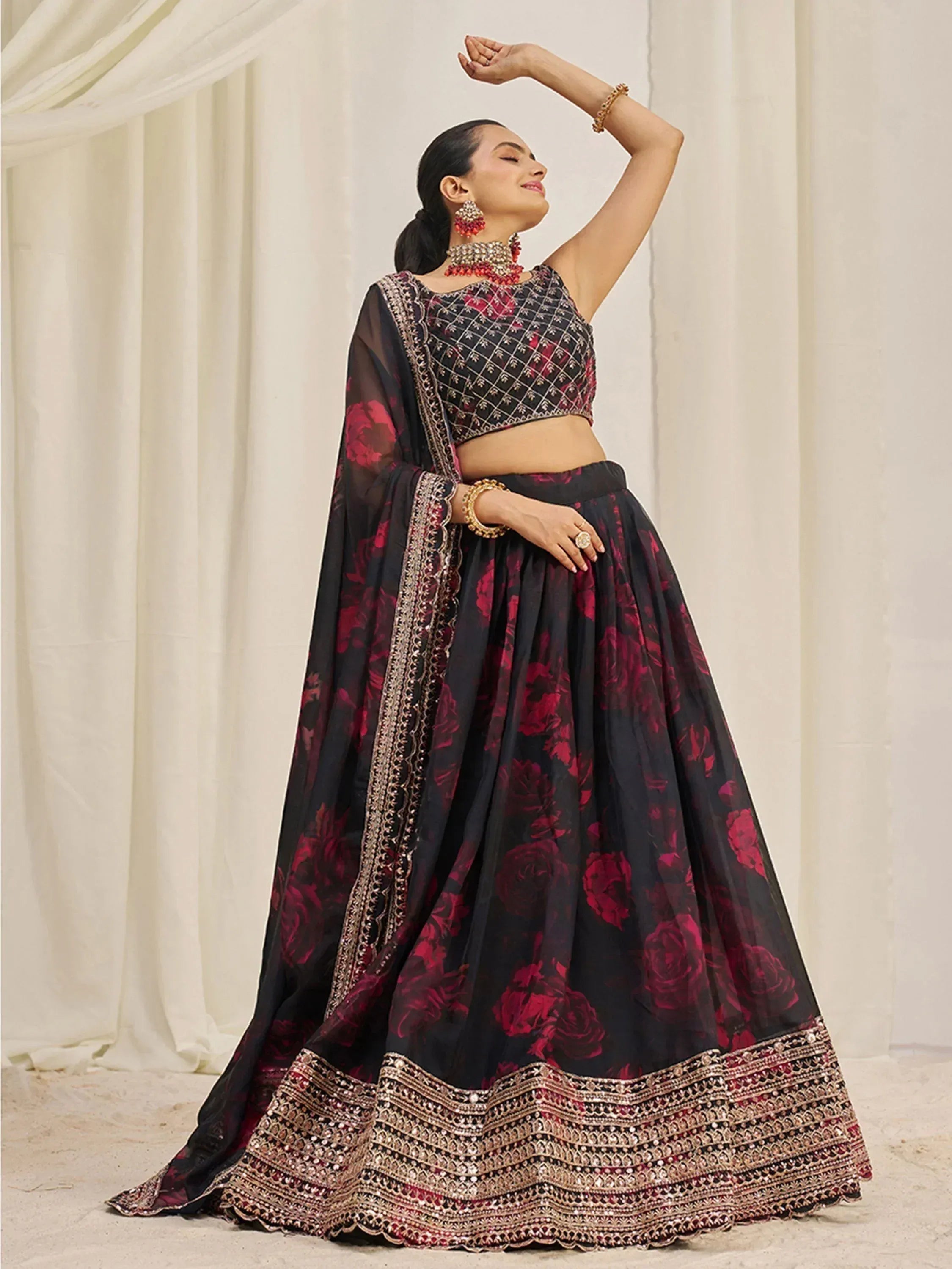 Black and red floral lehenga choli with intricate embroidery and embellished border