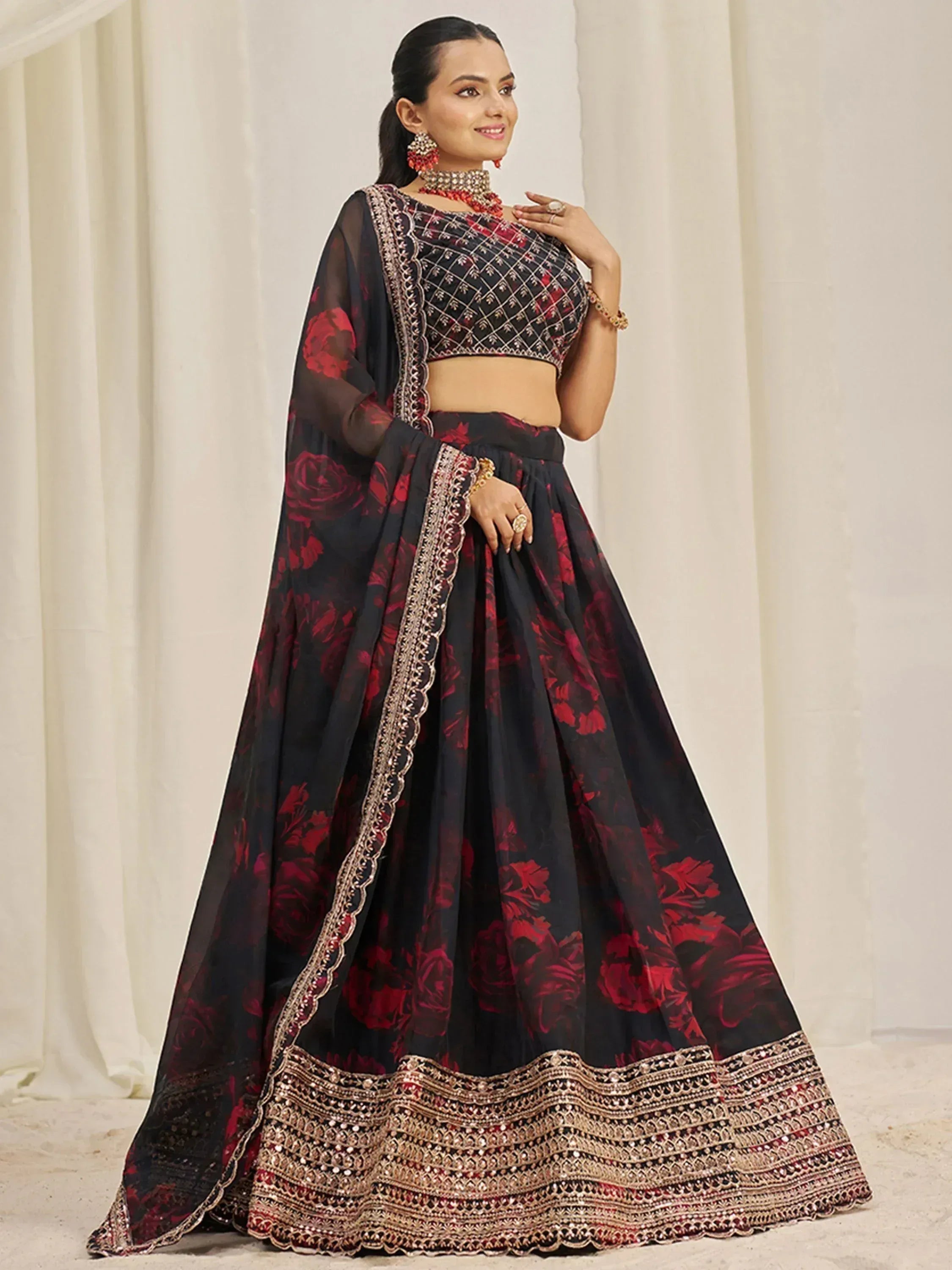 Black and red floral lehenga choli with intricate gold embroidery and sheer dupatta