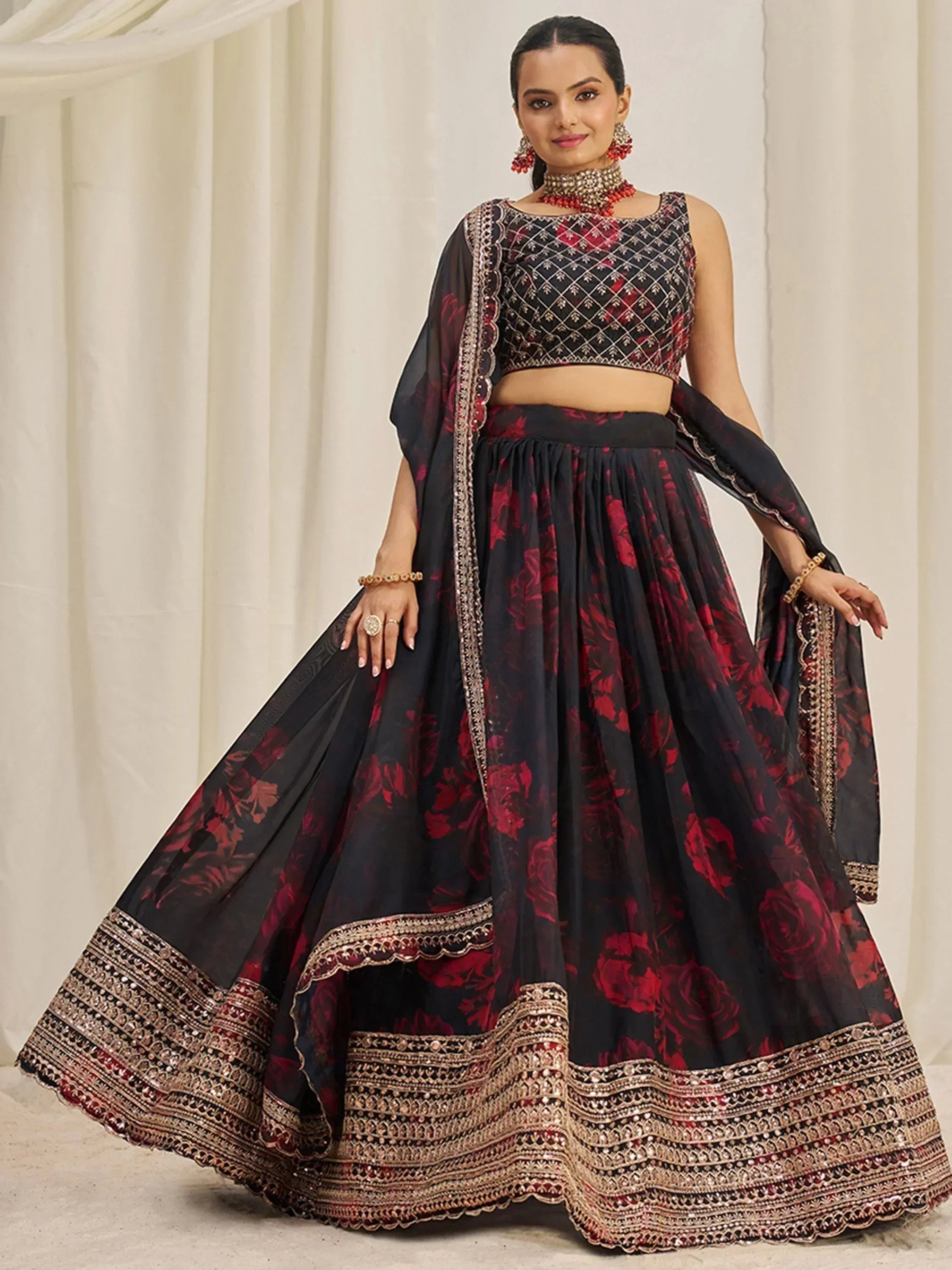 Black and red floral lehenga choli with intricate gold embroidery and embellished border