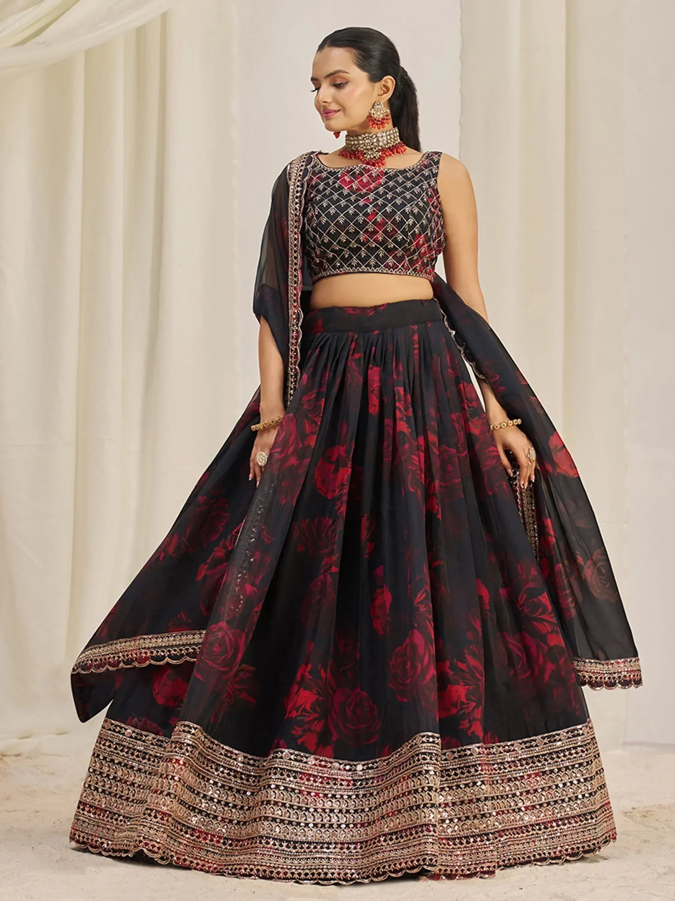 Black and red floral lehenga choli with intricate embroidery and gold detailing