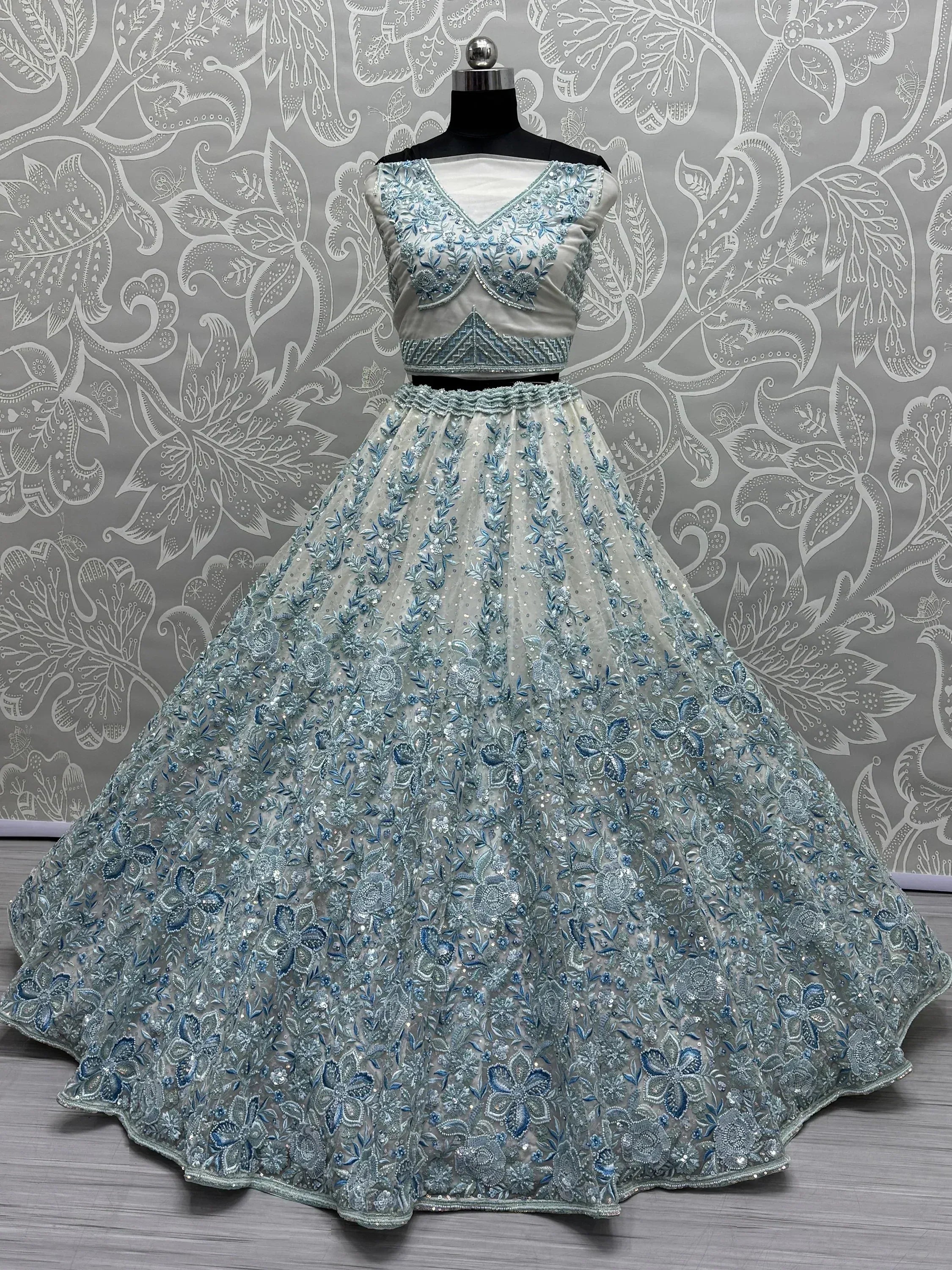 Elegant light blue and silver embroidered lehenga choli with floral detailing, perfect for Indian ethnic occasions.