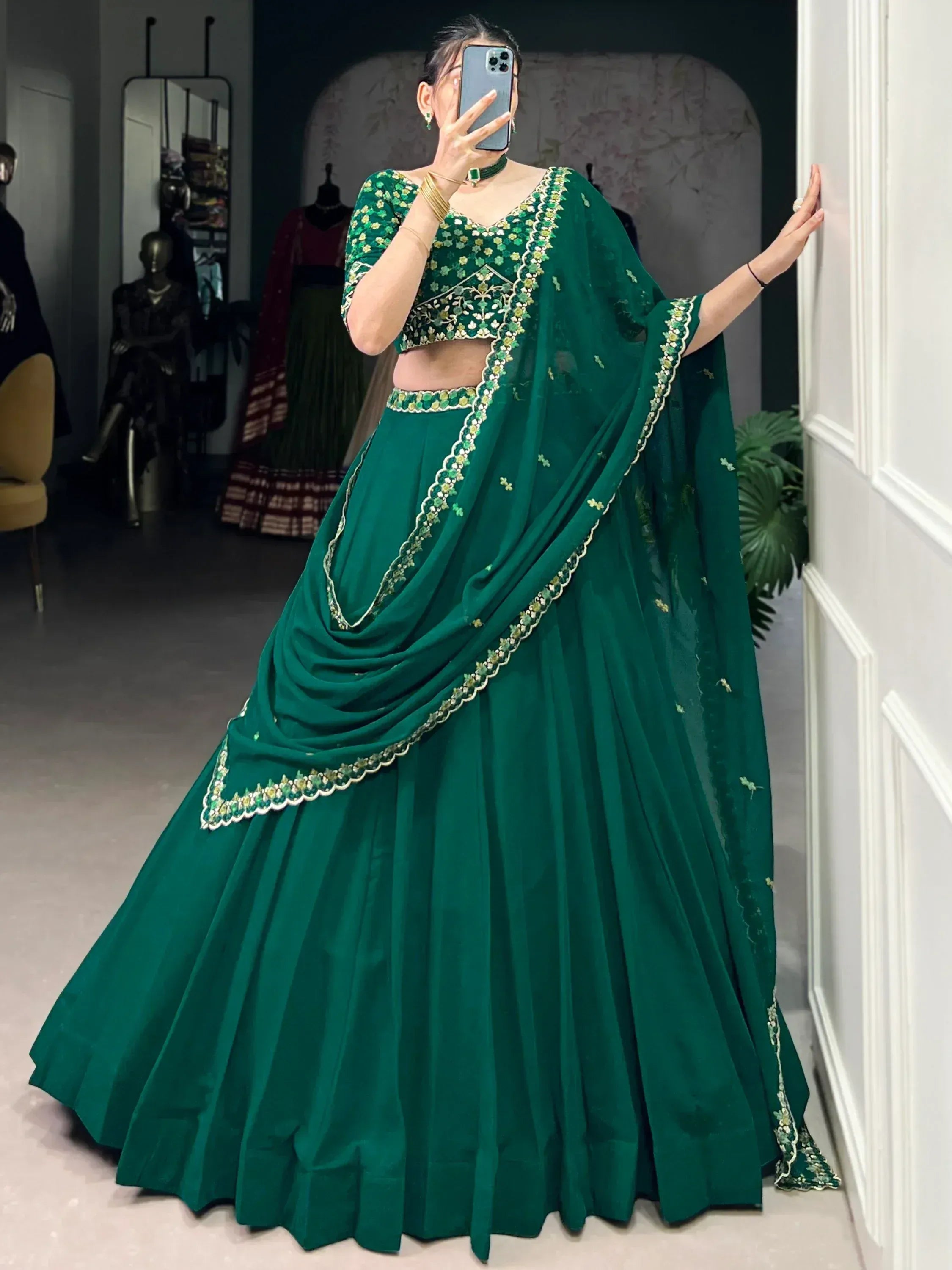 Emerald green designer lehenga choli with floral embroidery, perfect for Indian ethnic wear occasions.