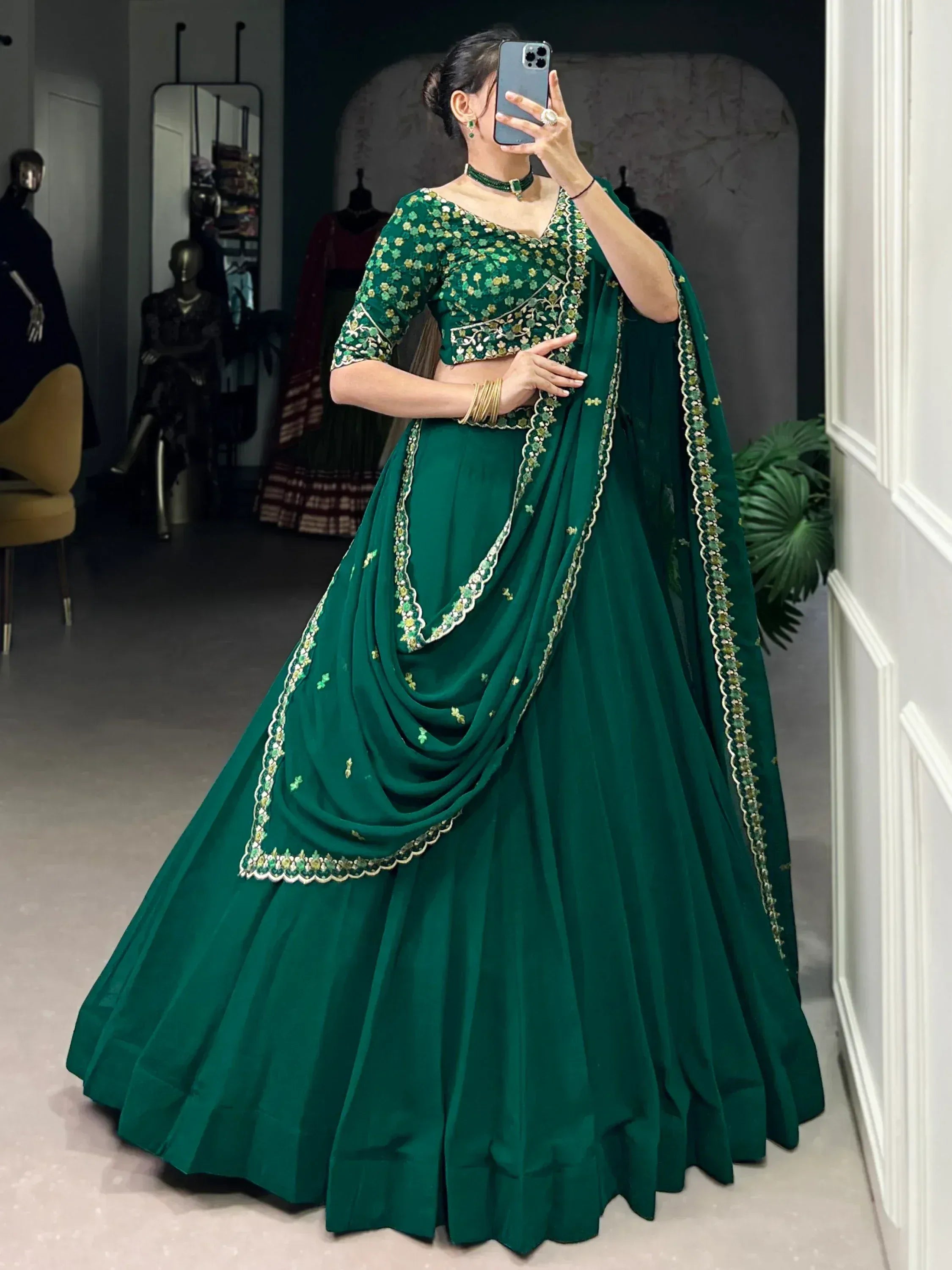Emerald green designer lehenga choli with floral embroidery, perfect for Indian weddings and festive occasions.