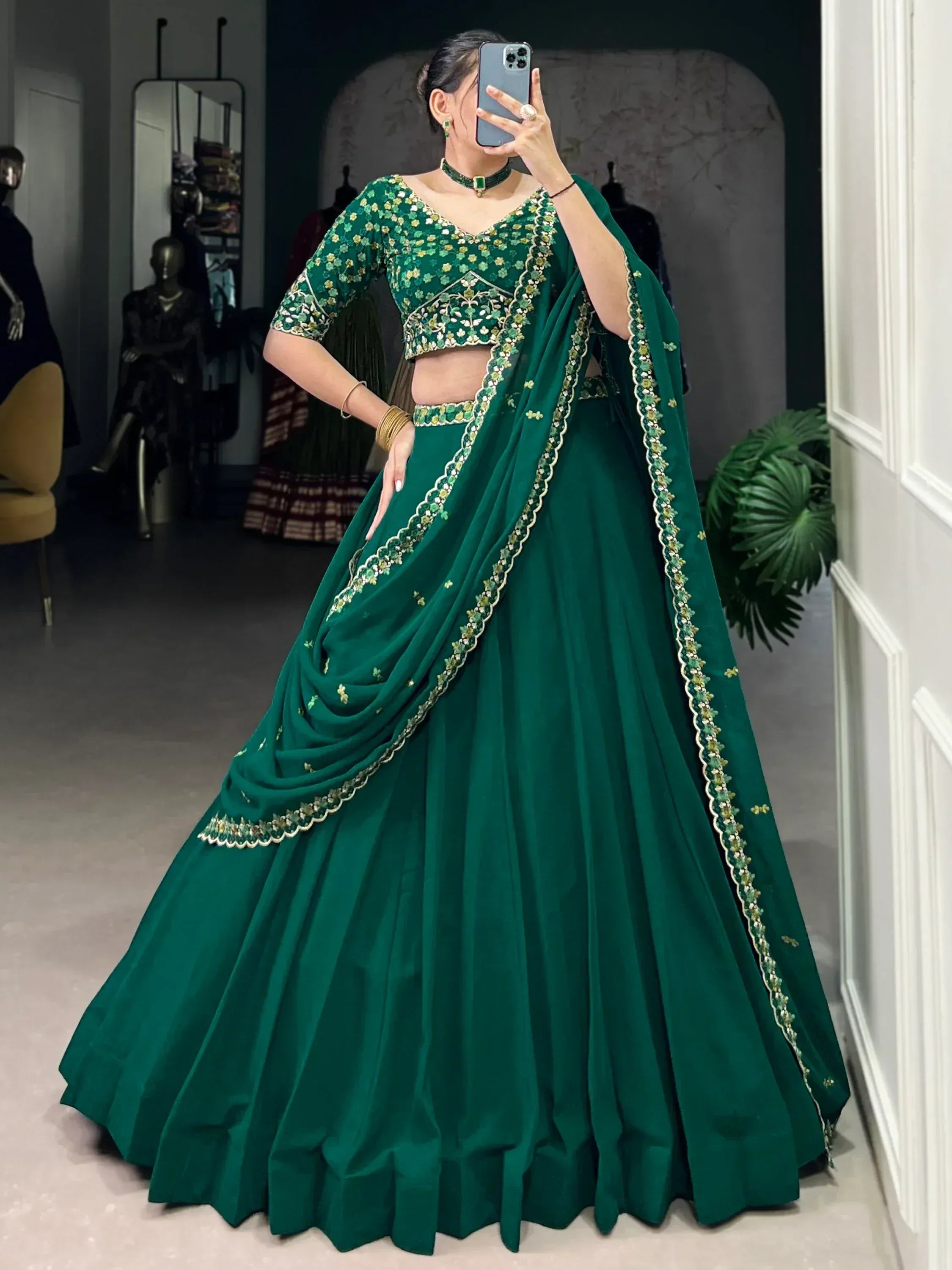 Emerald green designer lehenga choli with floral embroidery, perfect for weddings and festive occasions.