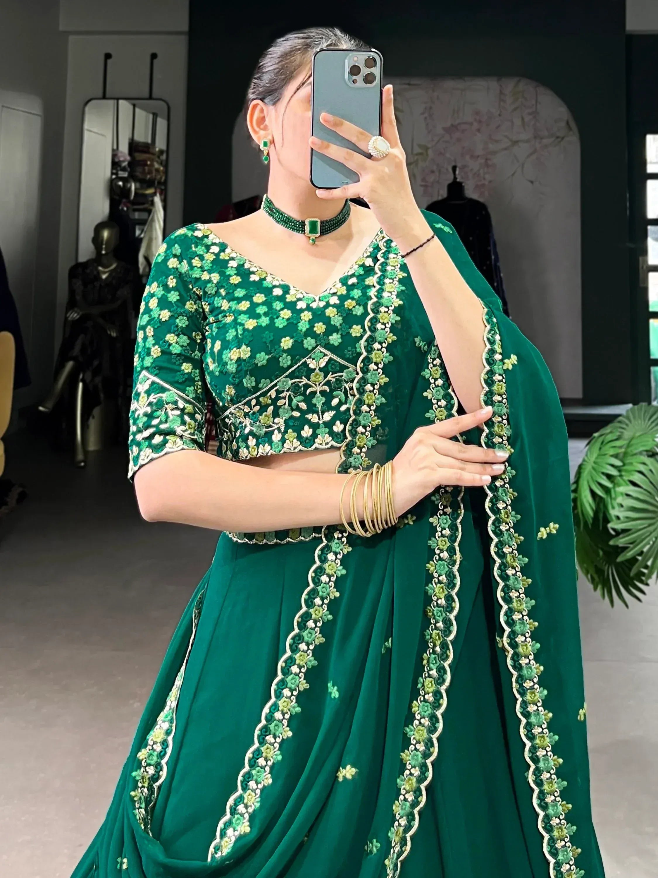 Emerald green embroidered lehenga choli with floral detailing, perfect for Indian ethnic wear occasions.