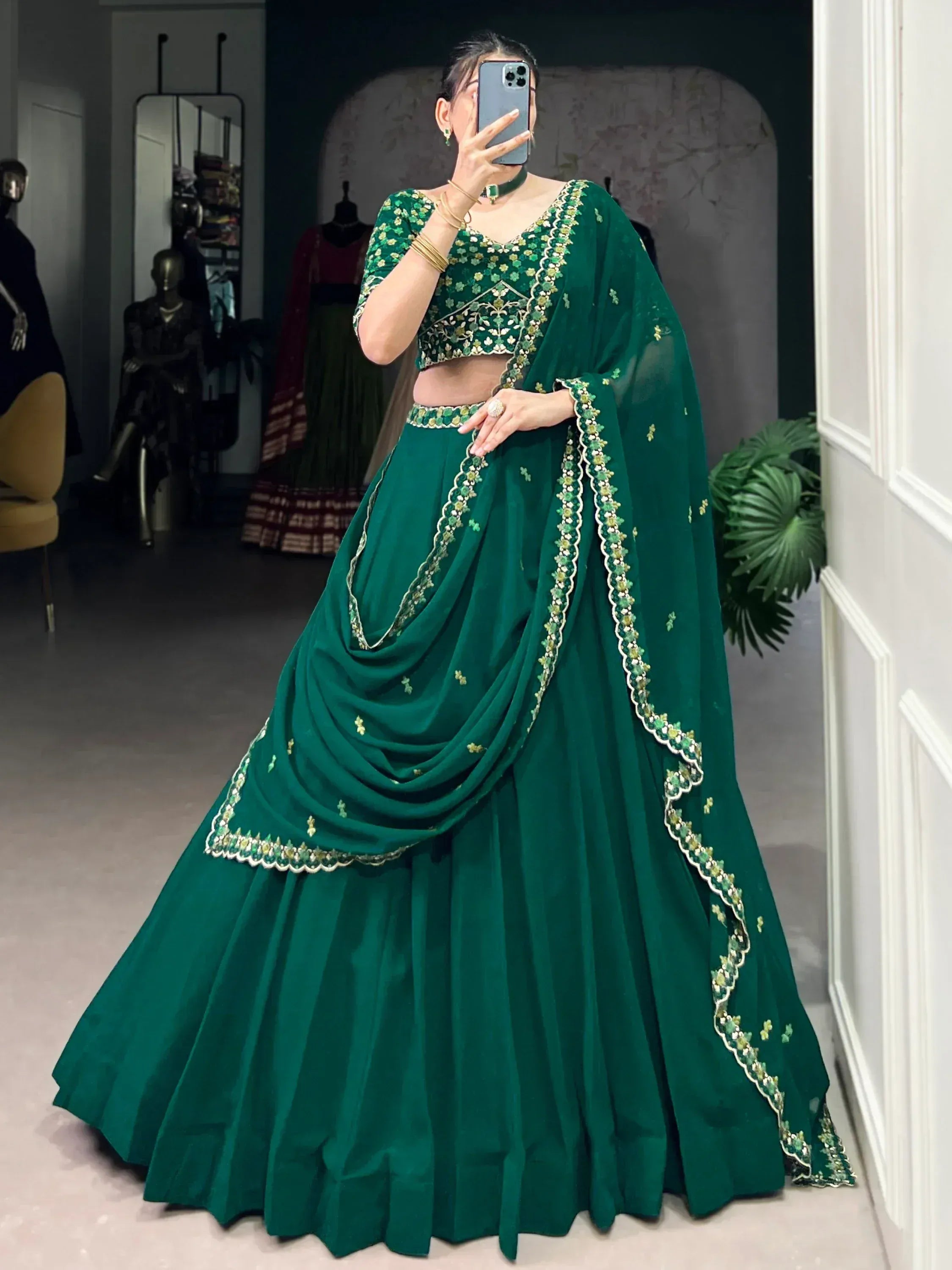 Emerald green designer lehenga choli with floral embroidery and dupatta, perfect for Indian ethnic wear occasions.