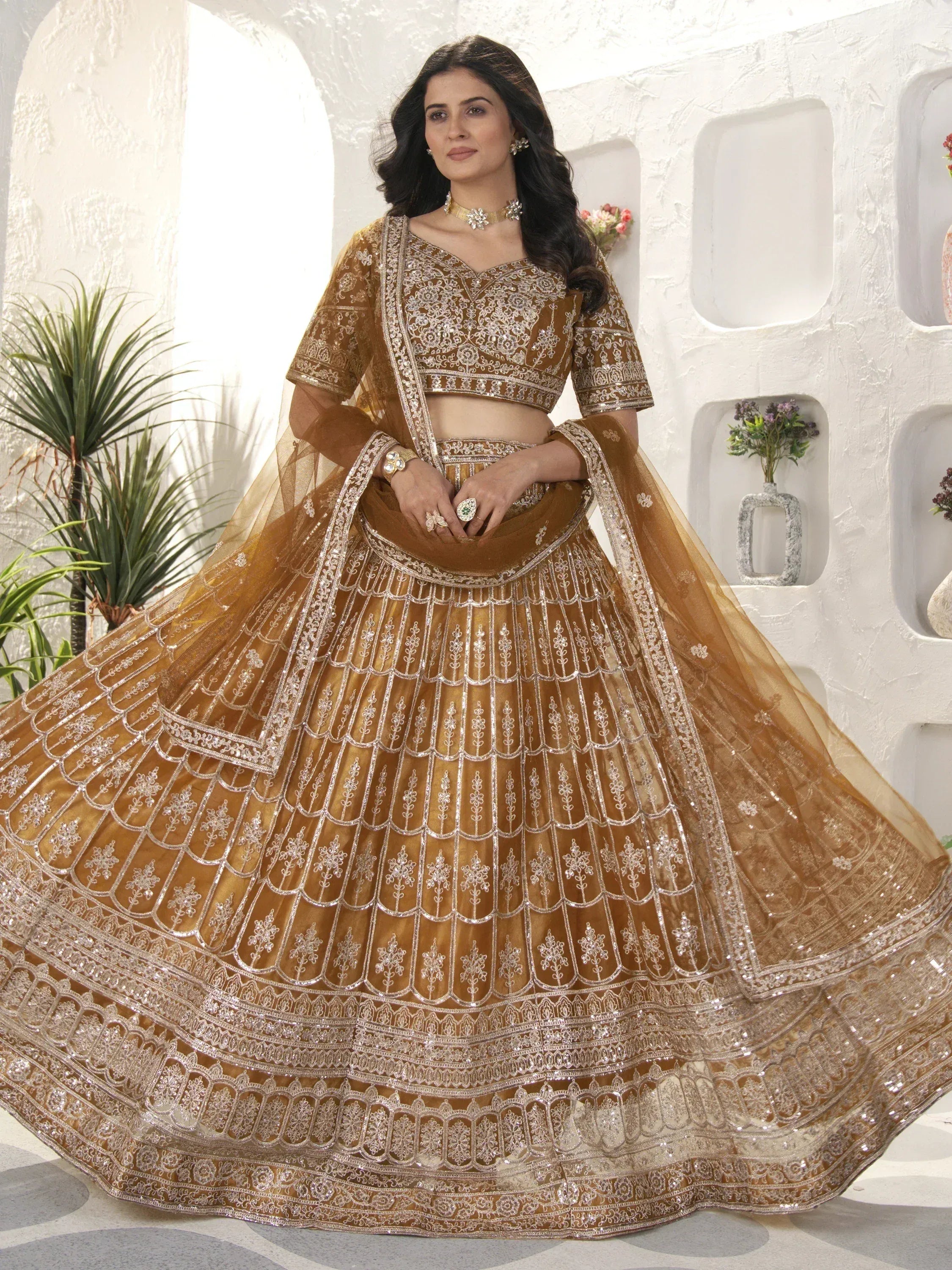 Elegant gold lehenga choli with intricate silver embroidery, perfect for Indian weddings and festive occasions.