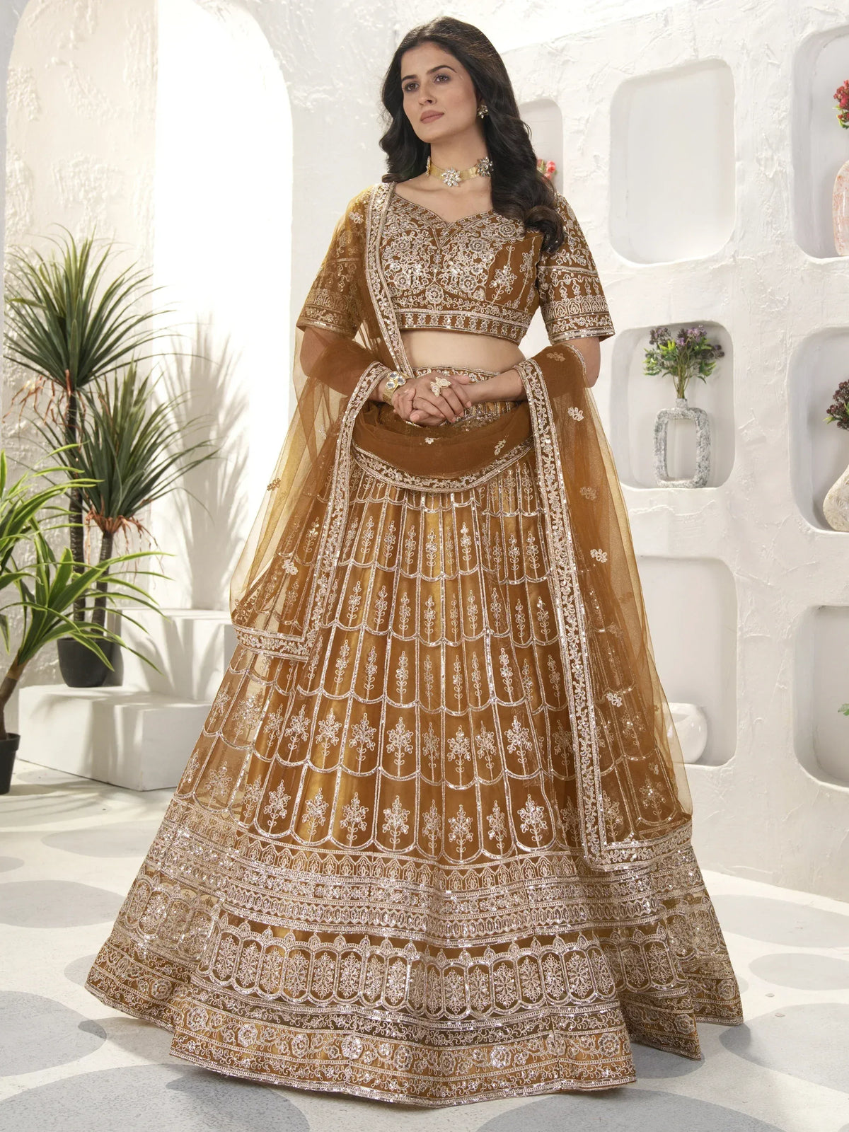 Elegant gold lehenga choli with intricate silver embroidery, perfect for Indian weddings and festive occasions.