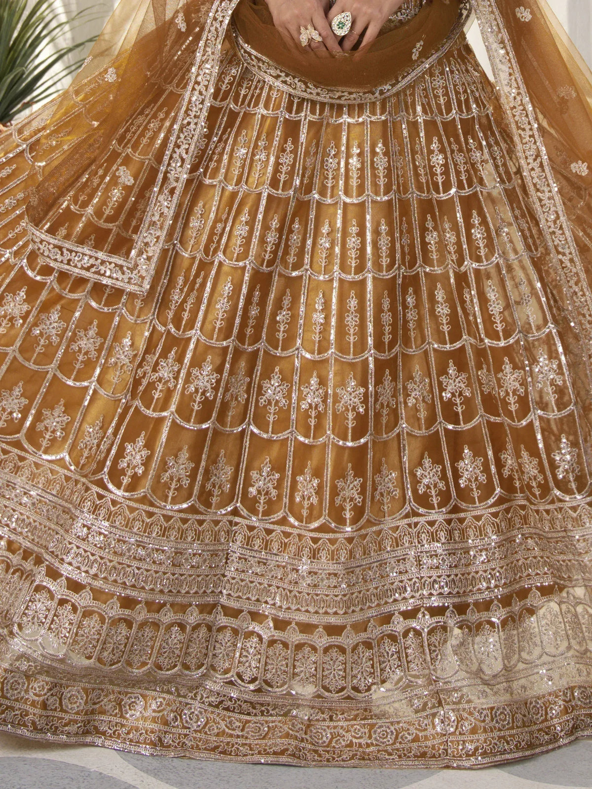 Golden designer lehenga with intricate silver embroidery and scalloped detailing for Indian ethnic wear