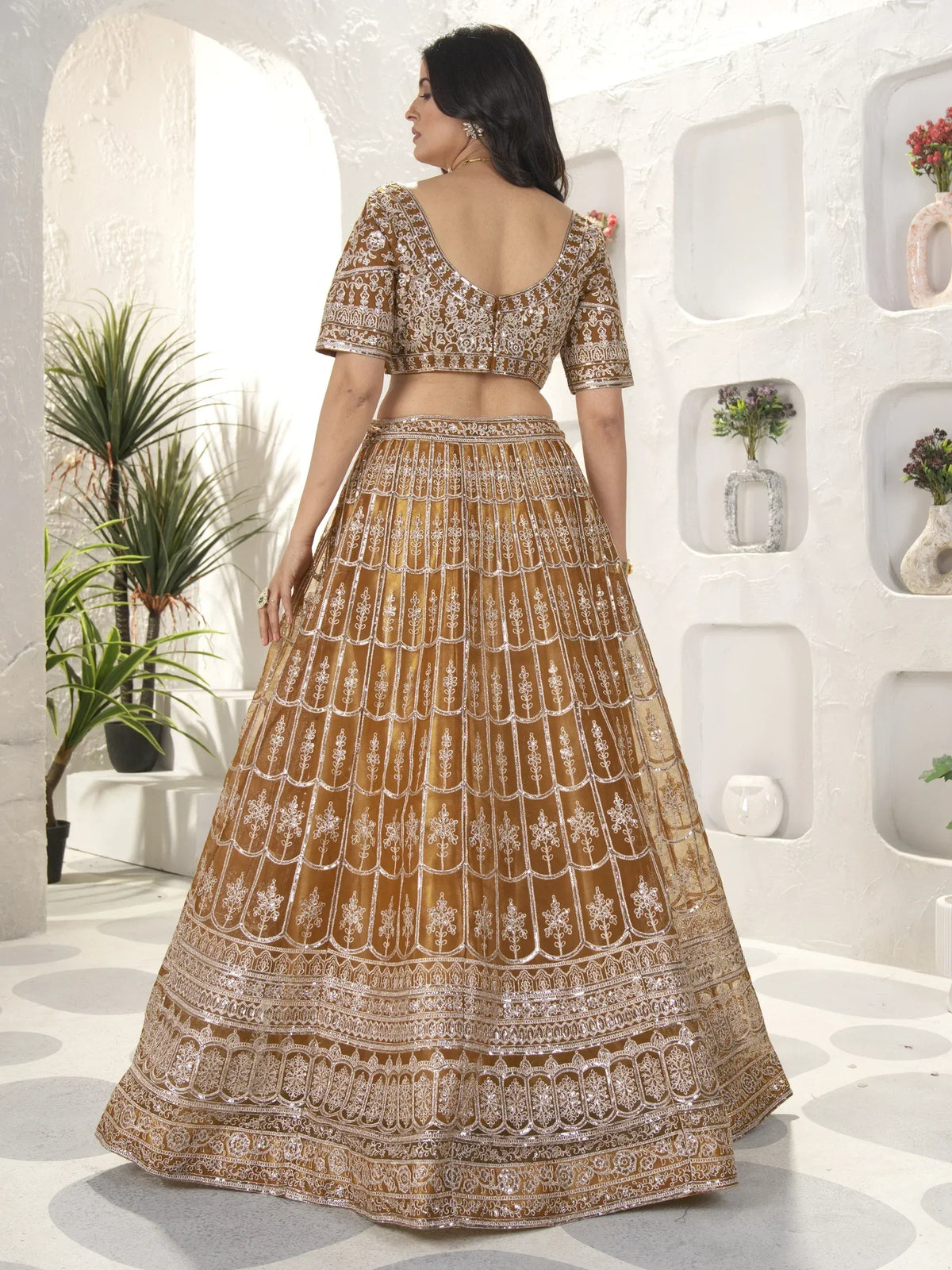 Golden embroidered lehenga choli with intricate silver detailing, perfect for Indian ethnic wear events.