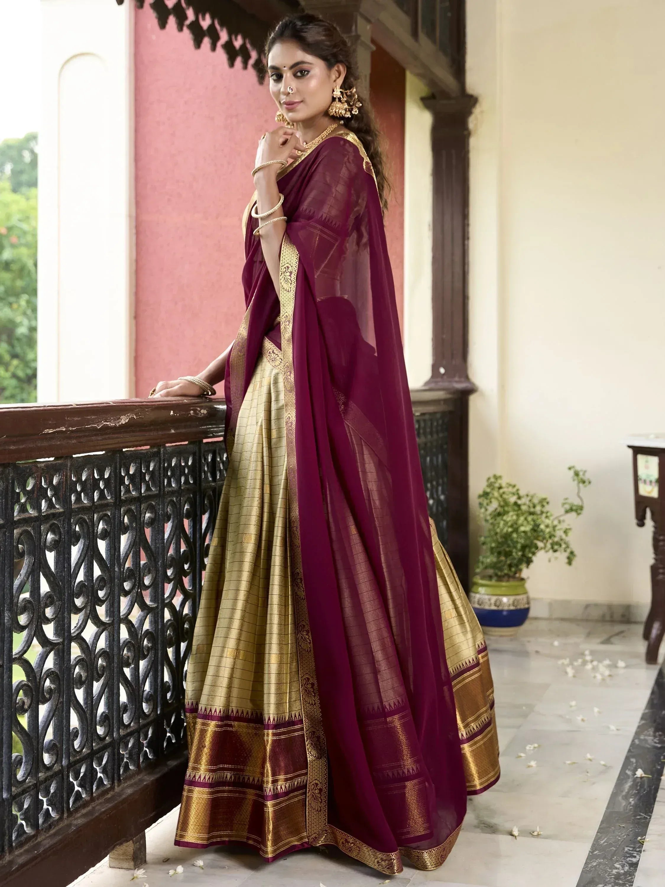 Elegant maroon and gold saree with intricate border, perfect for Indian ethnic occasions